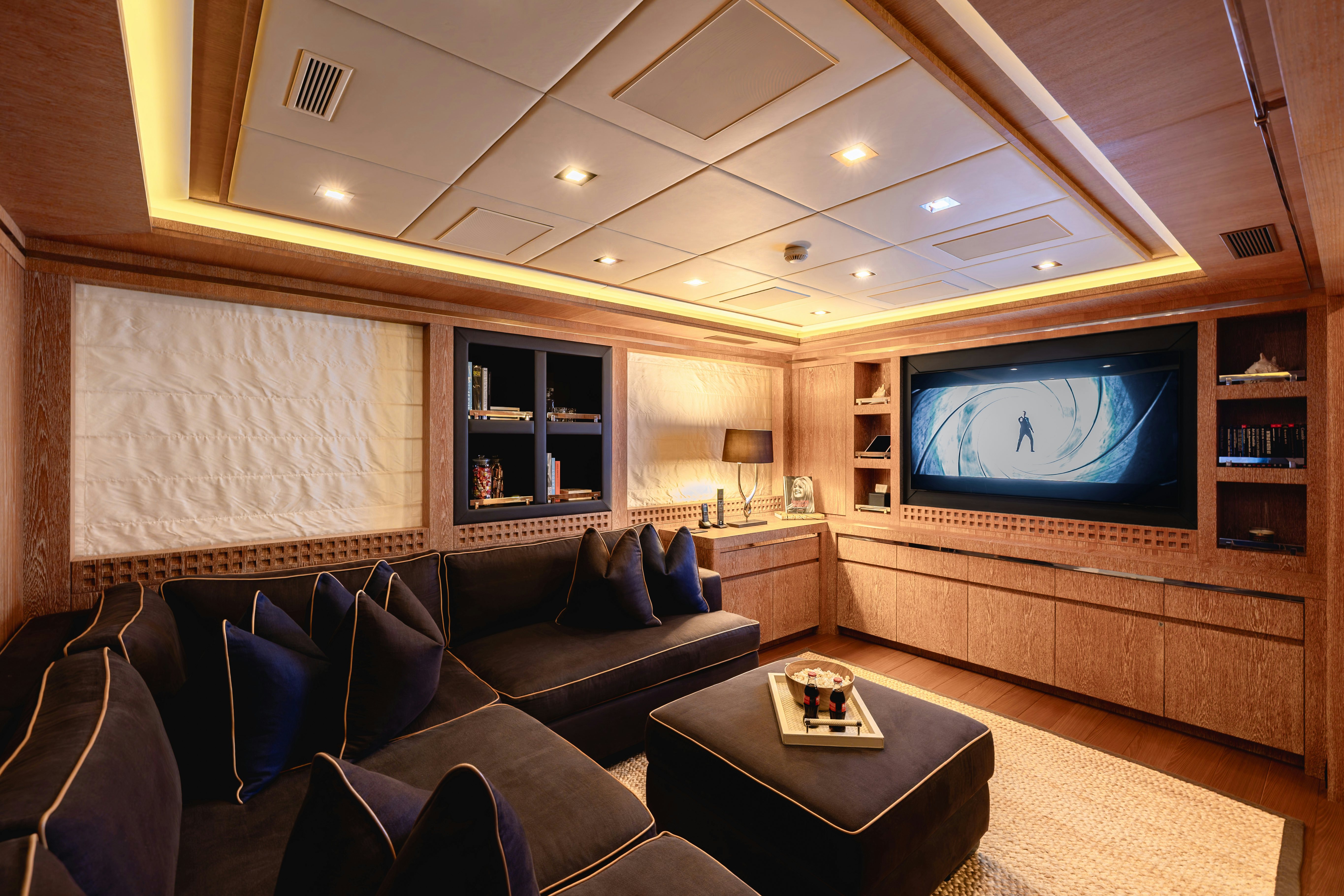 a living room with a large screen aboard ROYALE X Yacht for Charter