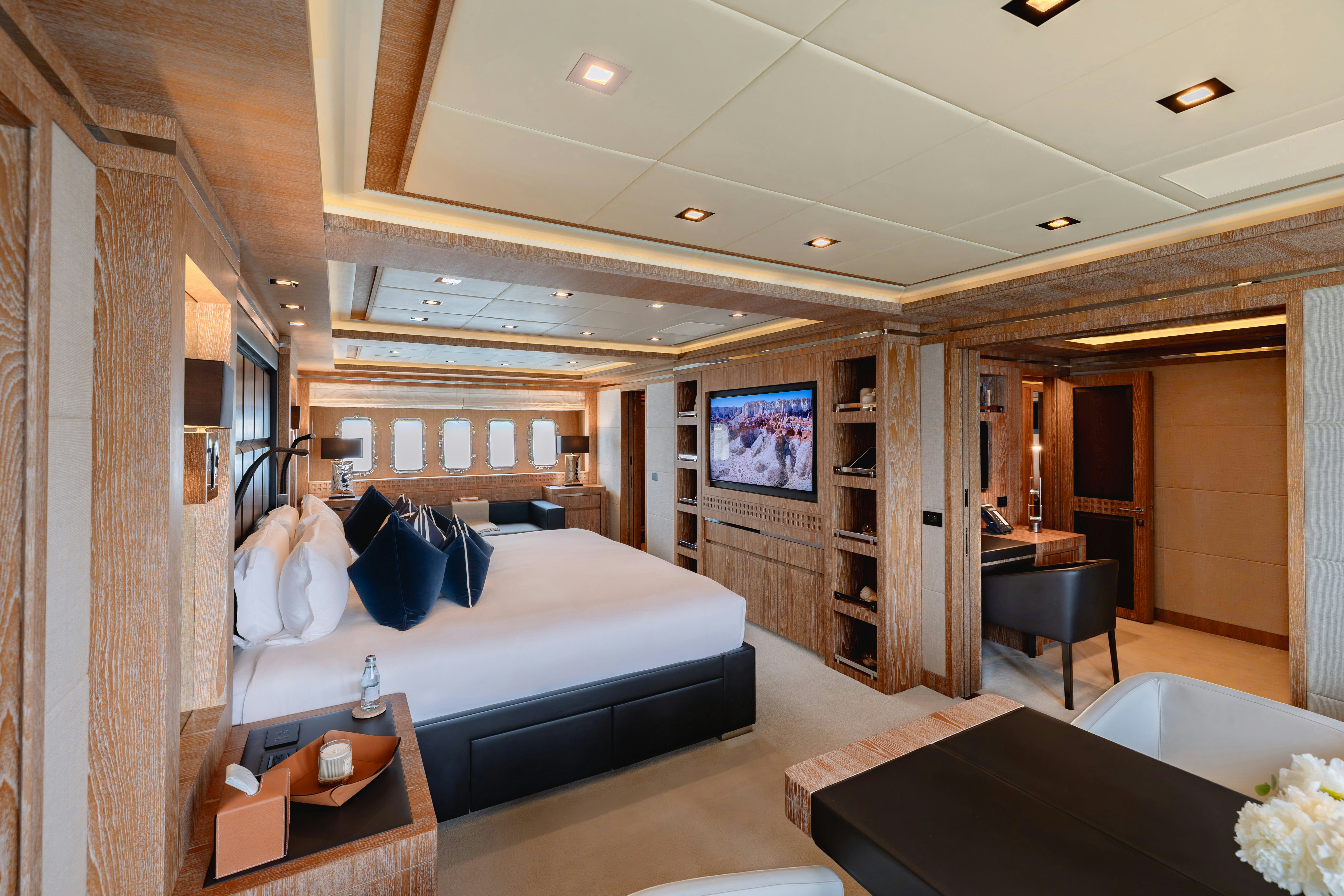 a bedroom with a bed and a tv aboard ROYALE X Yacht for Charter