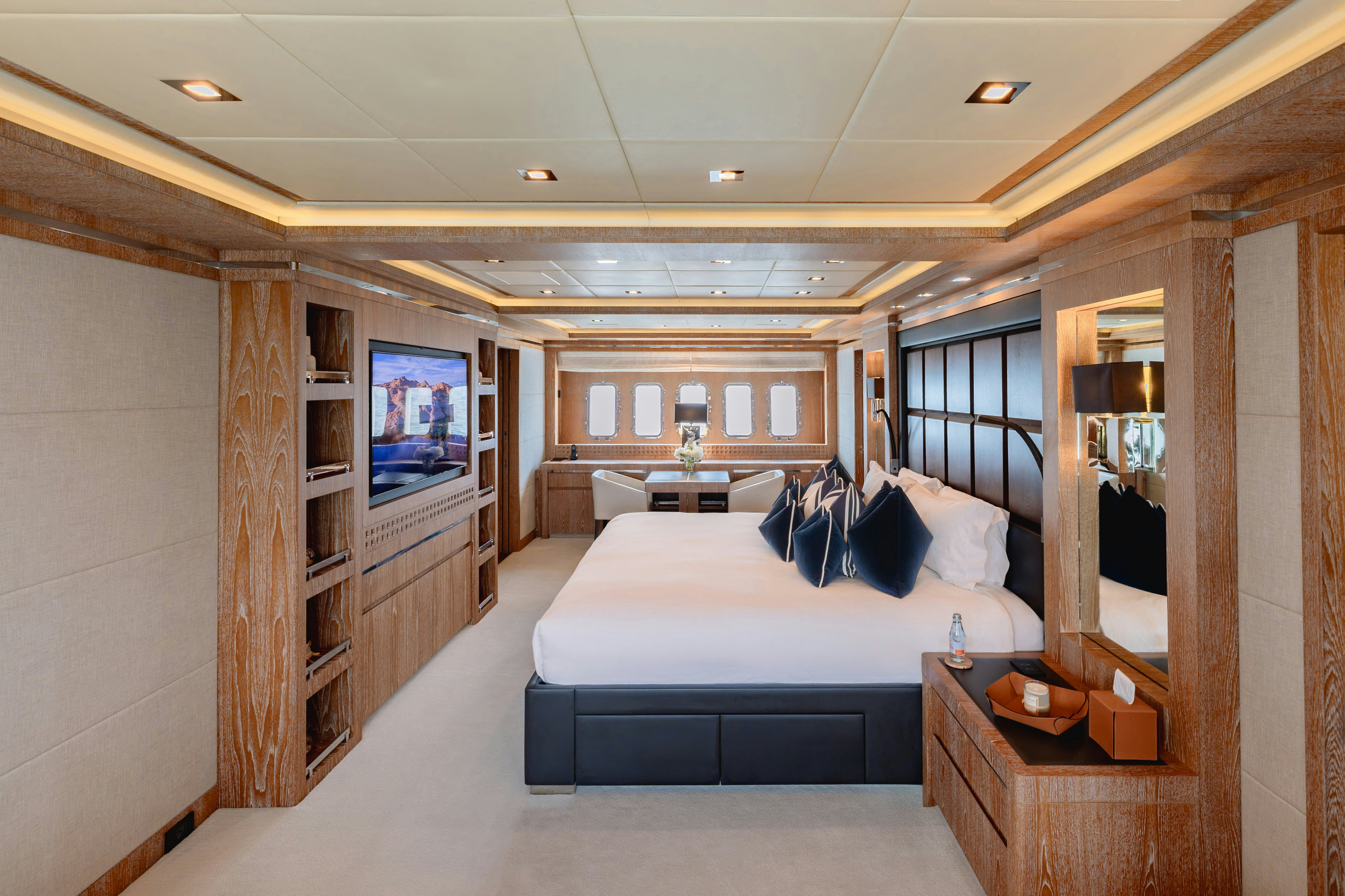 a room with a bed and a tv aboard ROYALE X Yacht for Charter