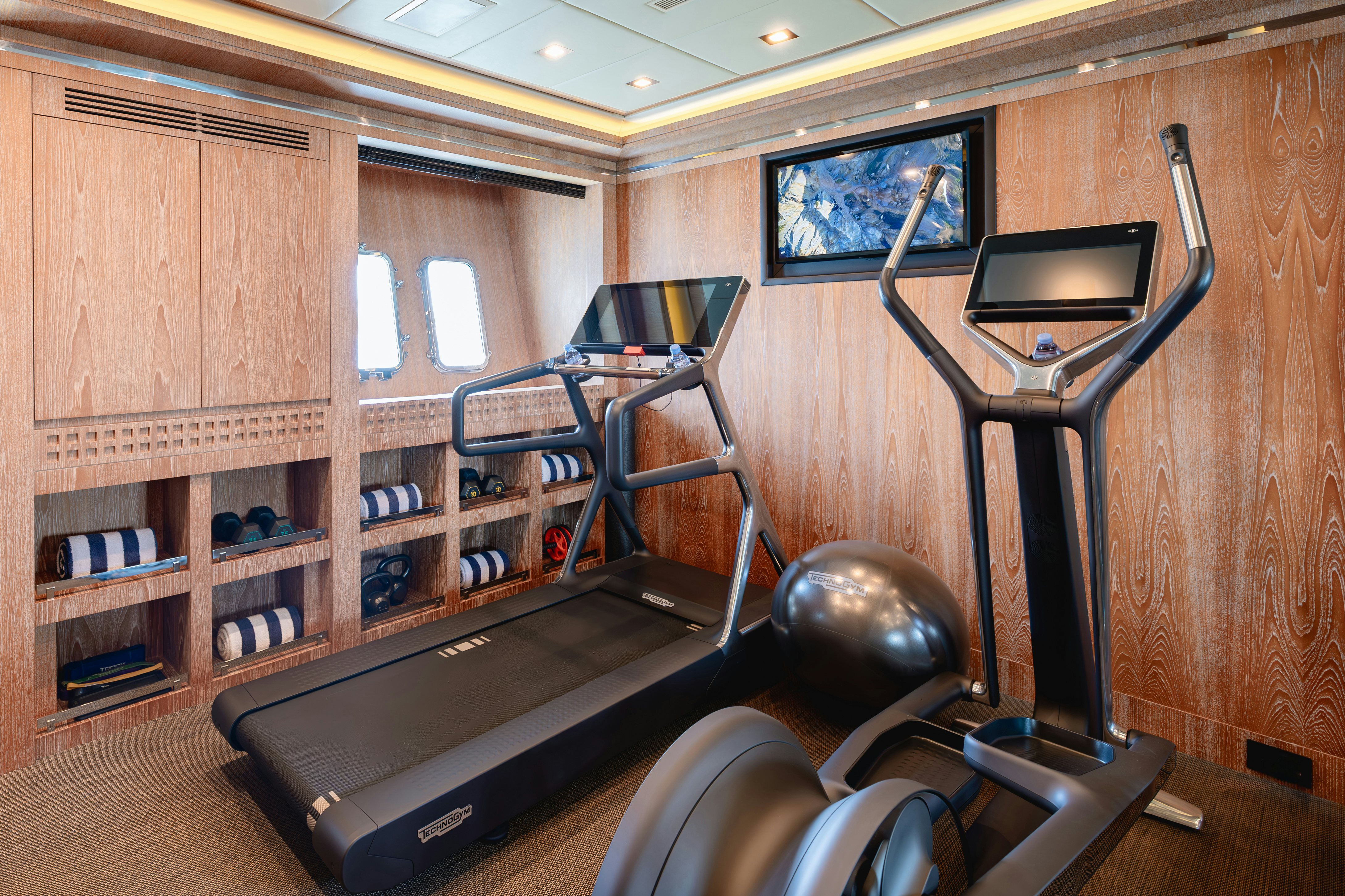 a gym with exercise equipment aboard ROYALE X Yacht for Charter