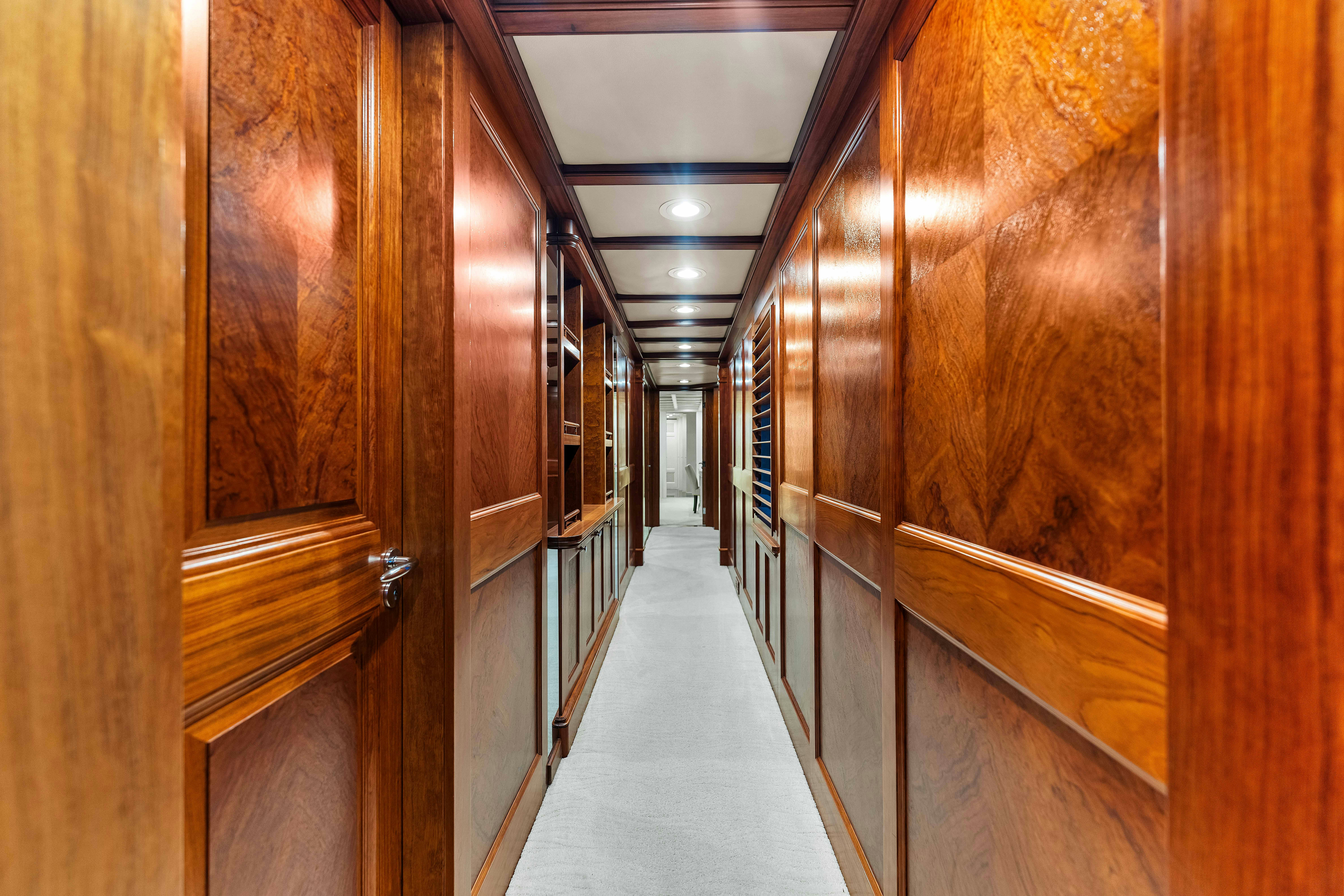 a long hallway with wooden doors aboard STAR DIAMOND Yacht for Charter
