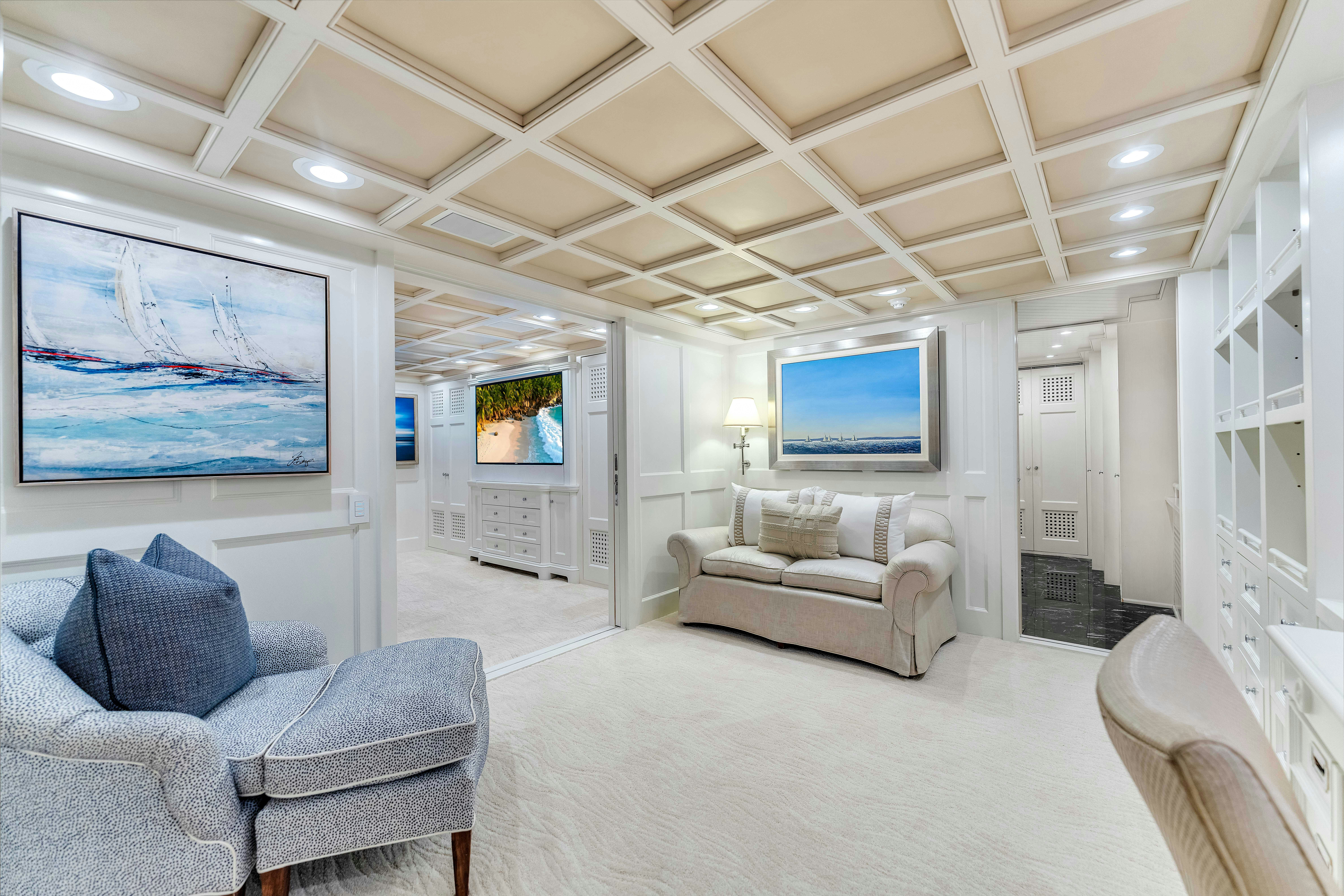 a living room with a large screen aboard STAR DIAMOND Yacht for Charter