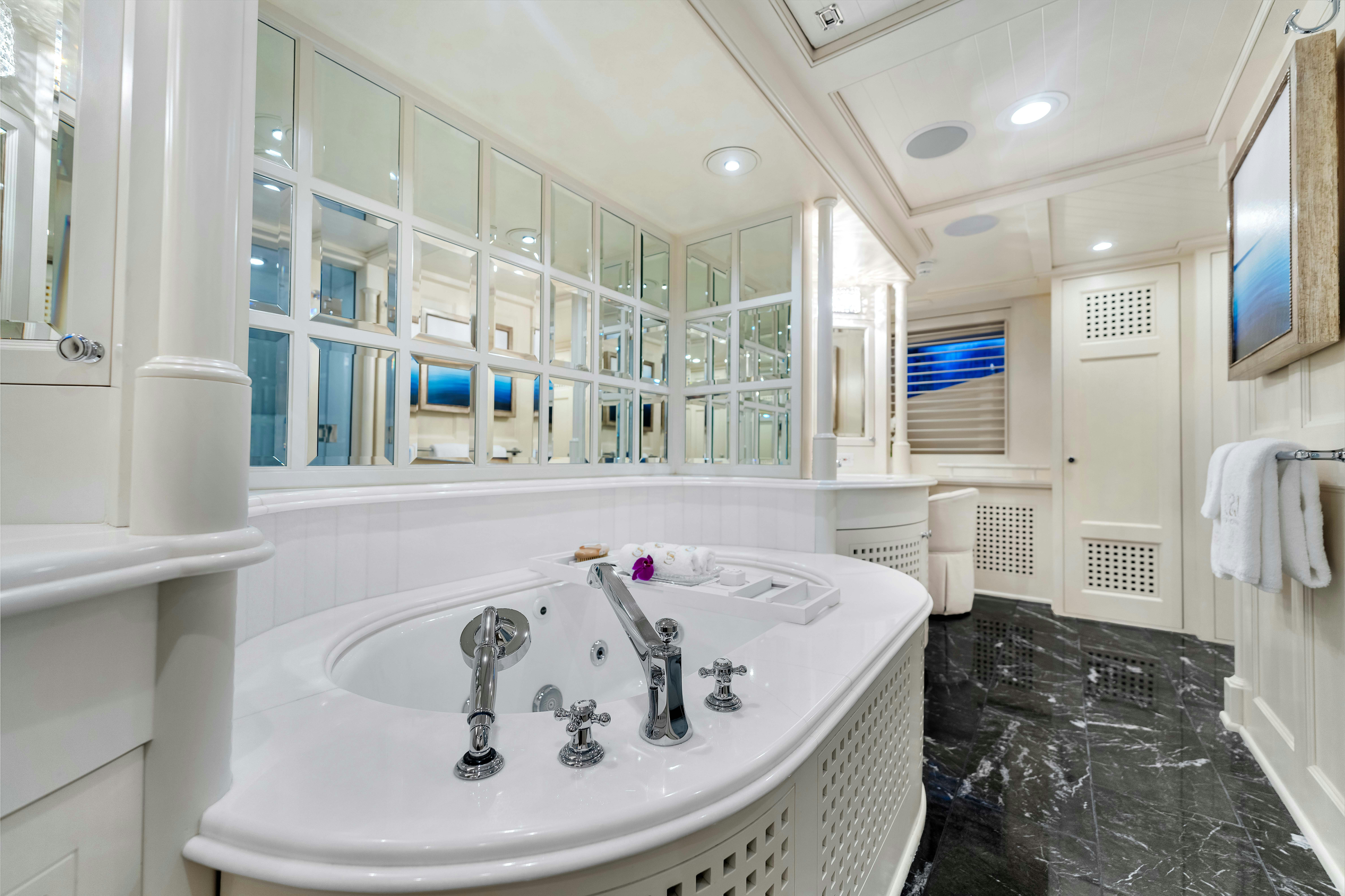 a bathroom with a large mirror aboard STAR DIAMOND Yacht for Sale