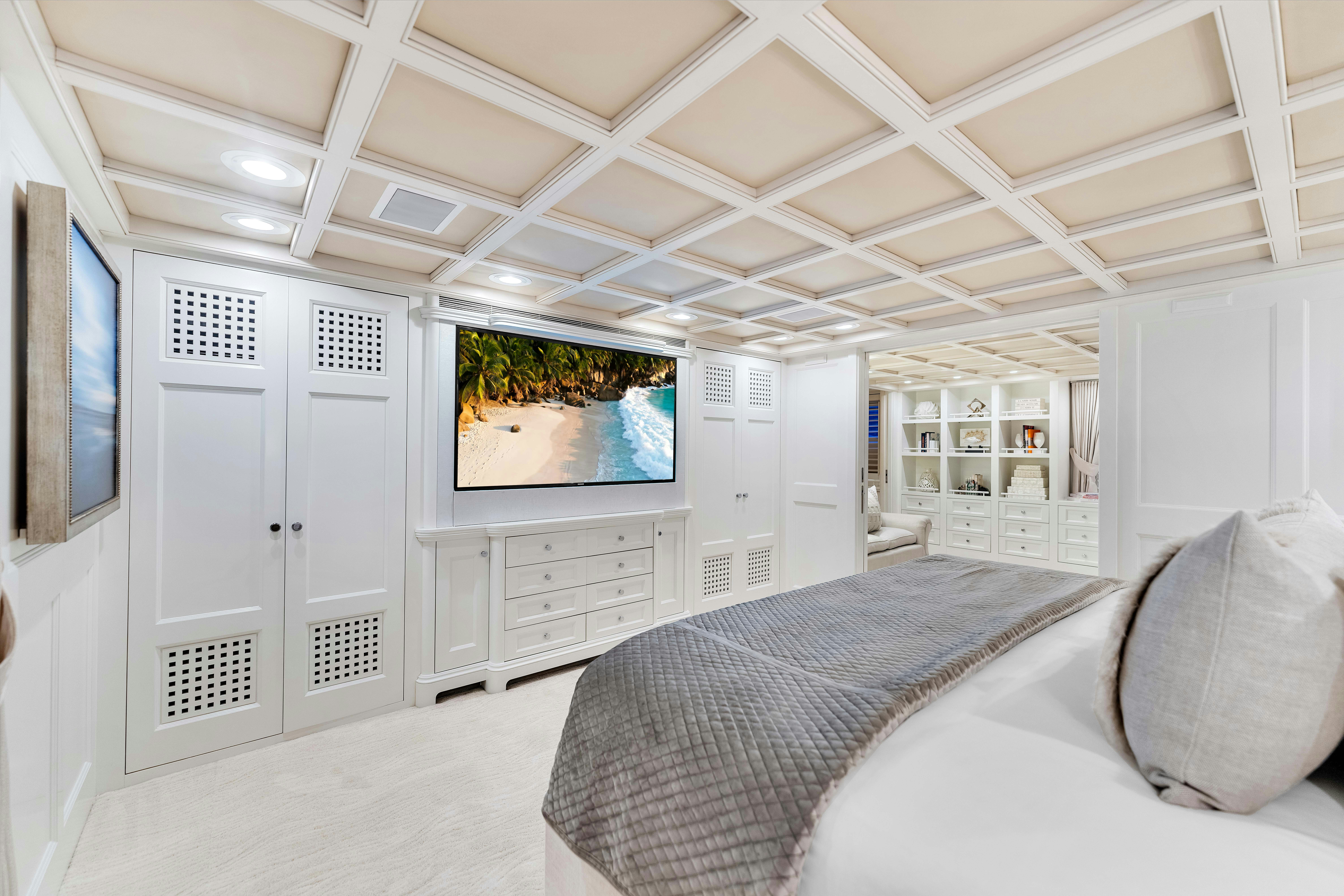 a bedroom with a large tv aboard STAR DIAMOND Yacht for Charter