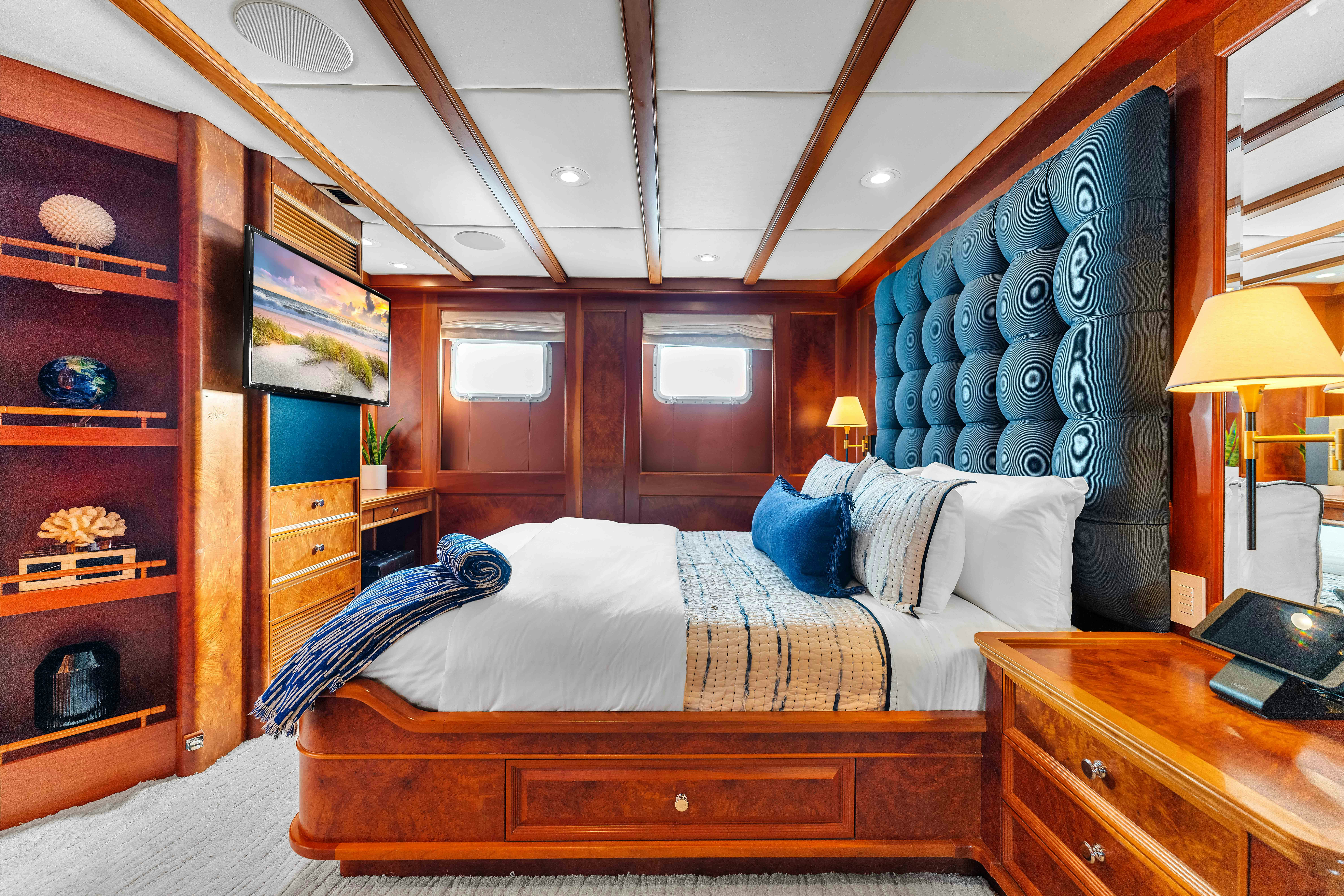 a bedroom with a bed and a desk aboard STAR DIAMOND Yacht for Charter