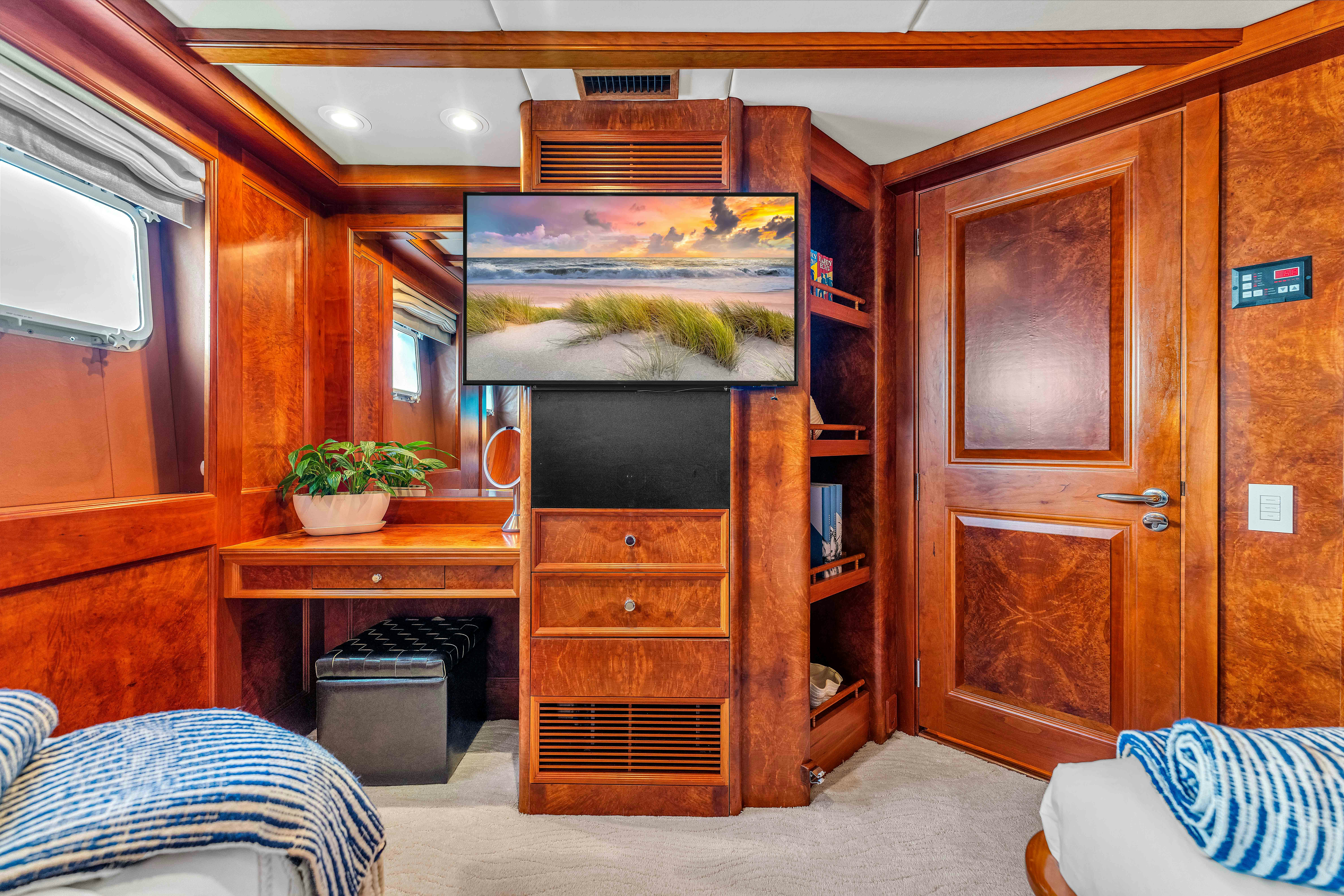 a room with a wood cabinet and a television in it aboard STAR DIAMOND Yacht for Charter
