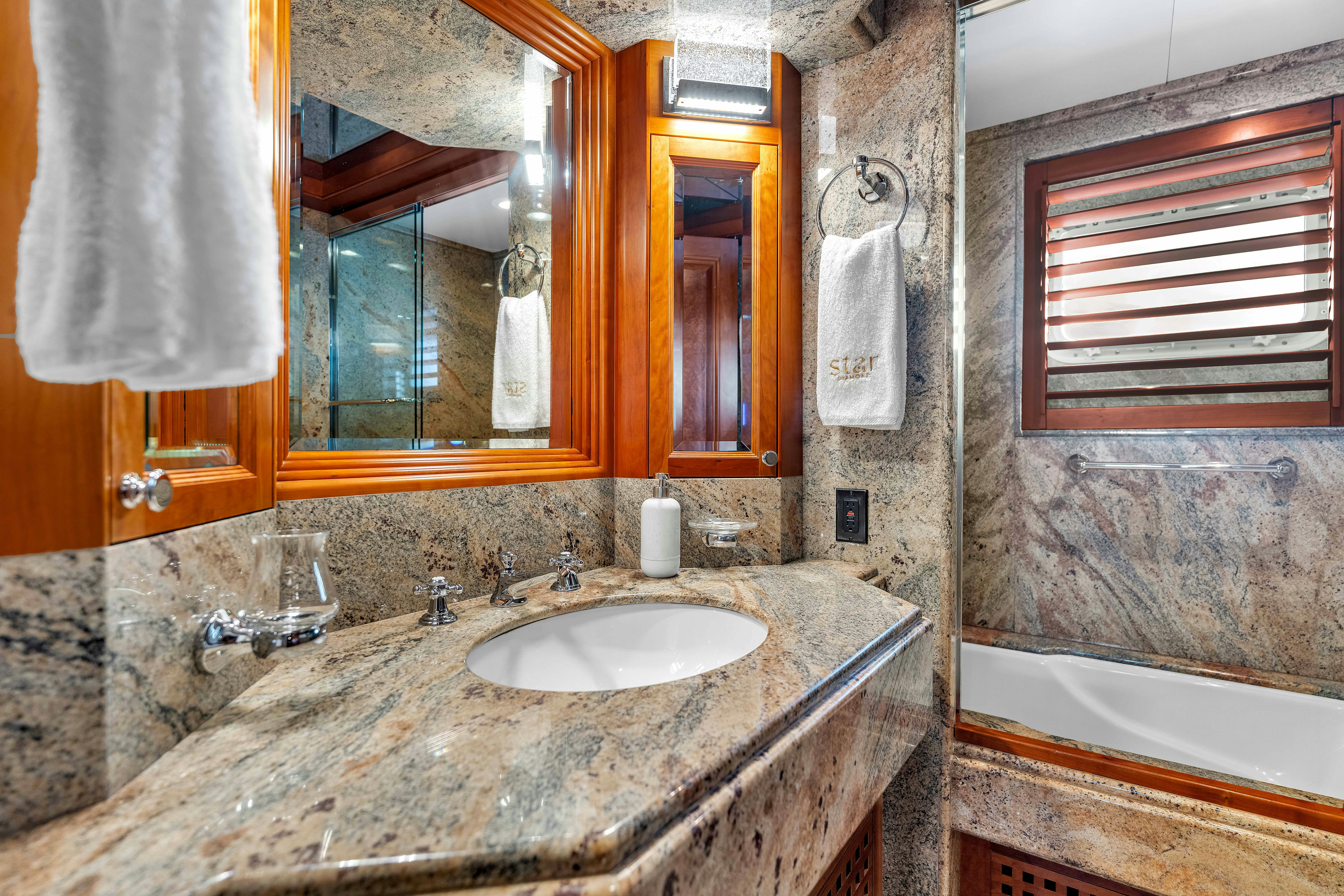 a bathroom with a sink and a bathtub aboard STAR DIAMOND Yacht for Charter