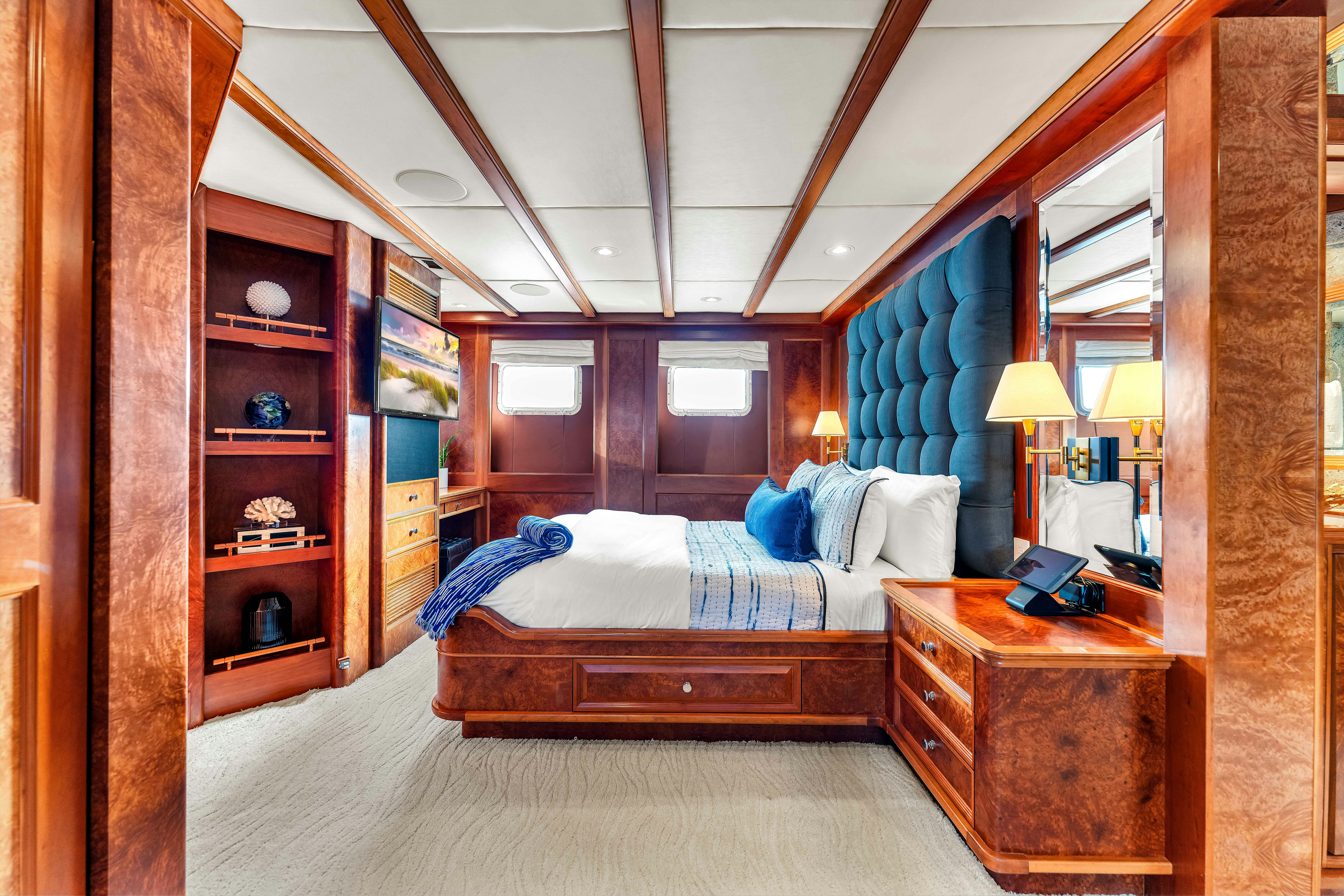 a bedroom with a bed and a desk aboard STAR DIAMOND Yacht for Charter