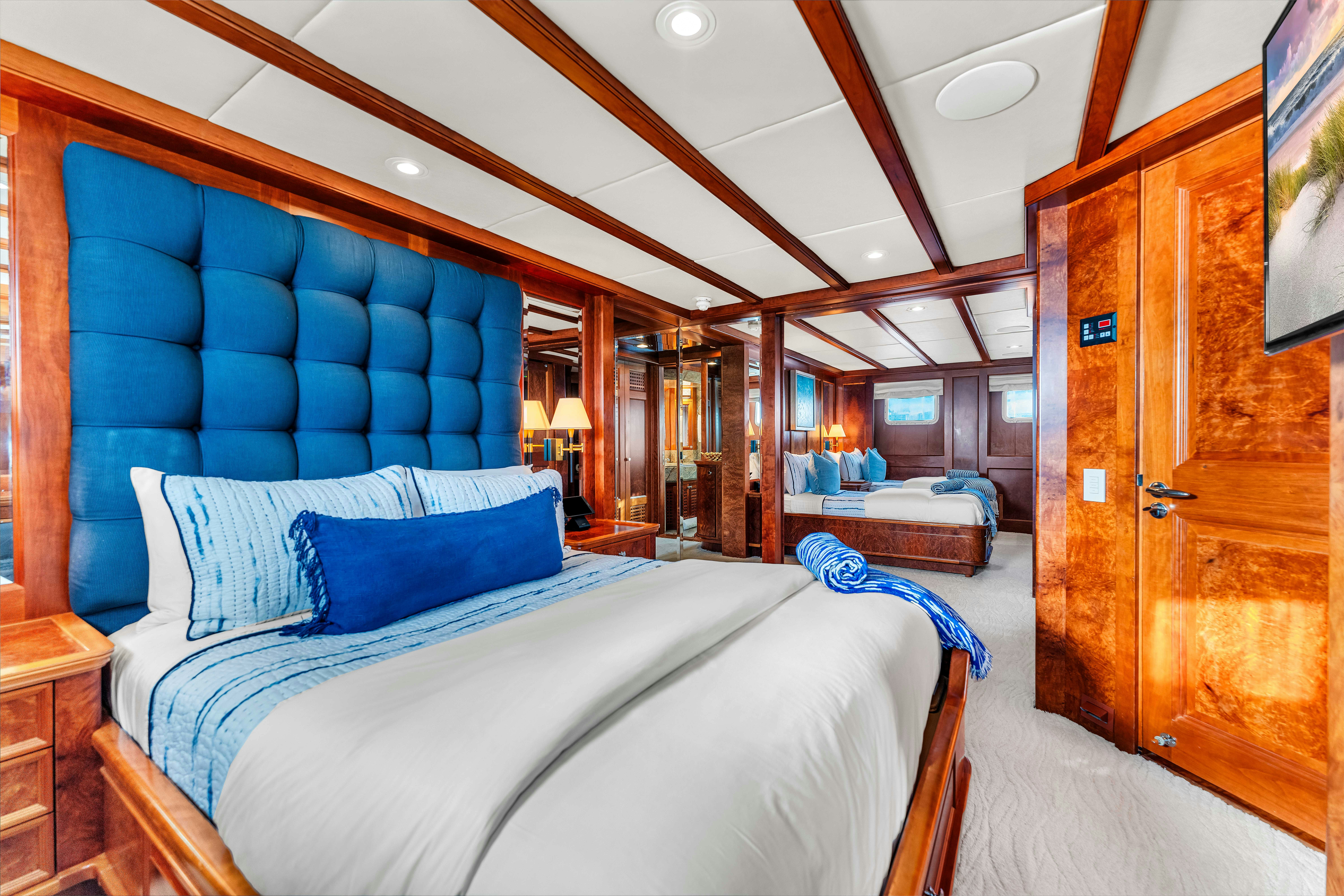 a room with a bed and a wood door aboard STAR DIAMOND Yacht for Charter
