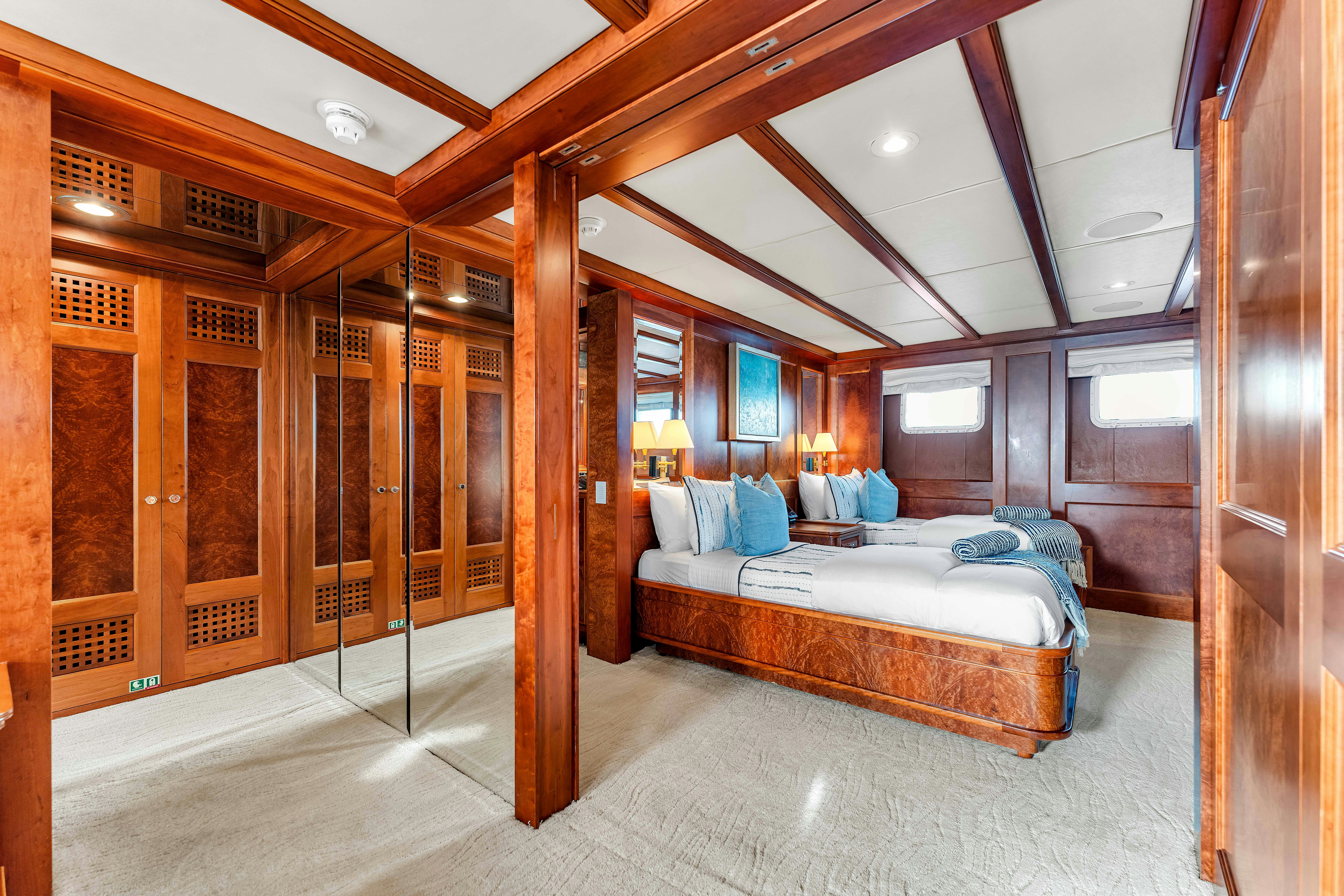 a bedroom with a bed and a mirror aboard STAR DIAMOND Yacht for Charter