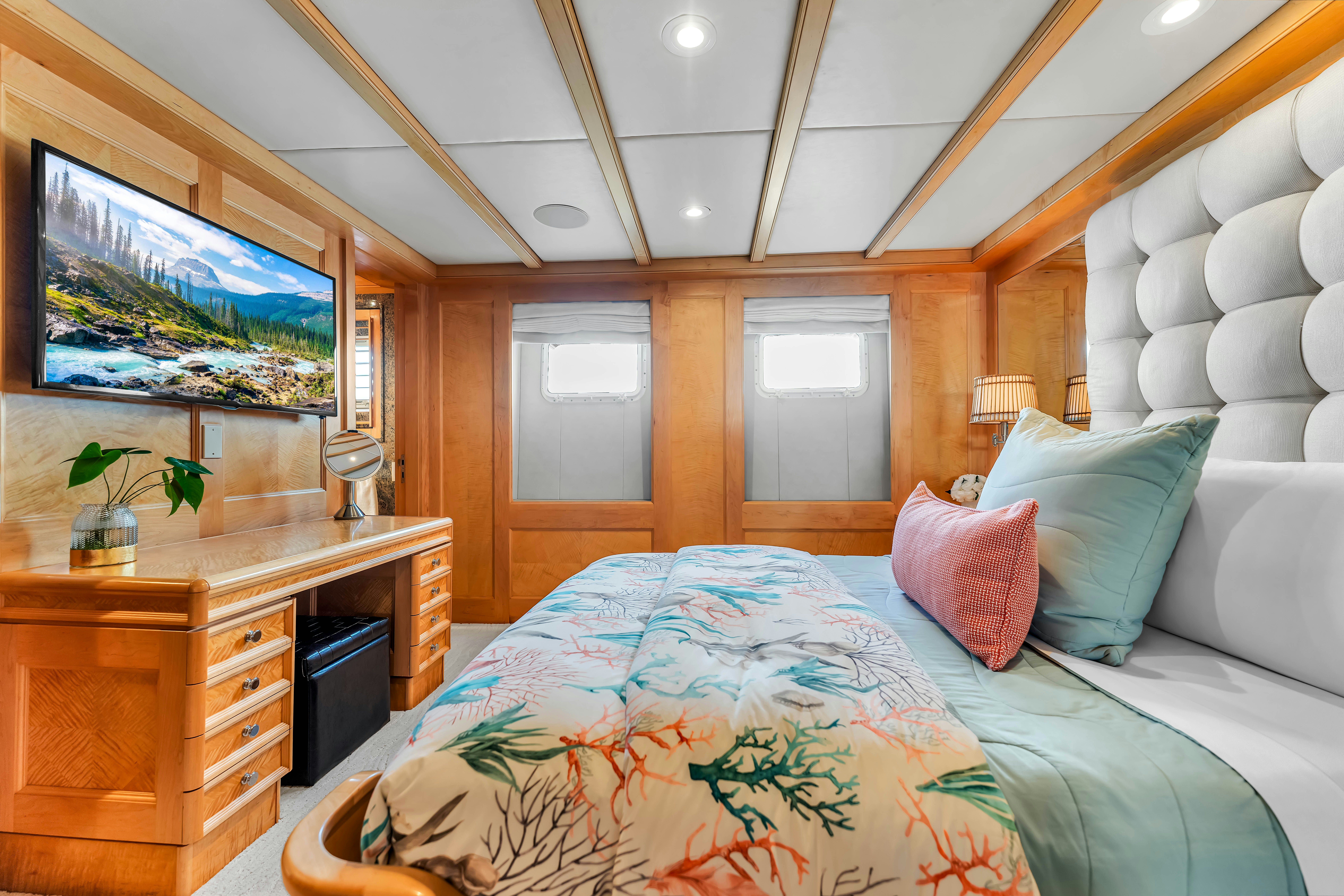 a bedroom with a bed and a tv aboard STAR DIAMOND Yacht for Charter