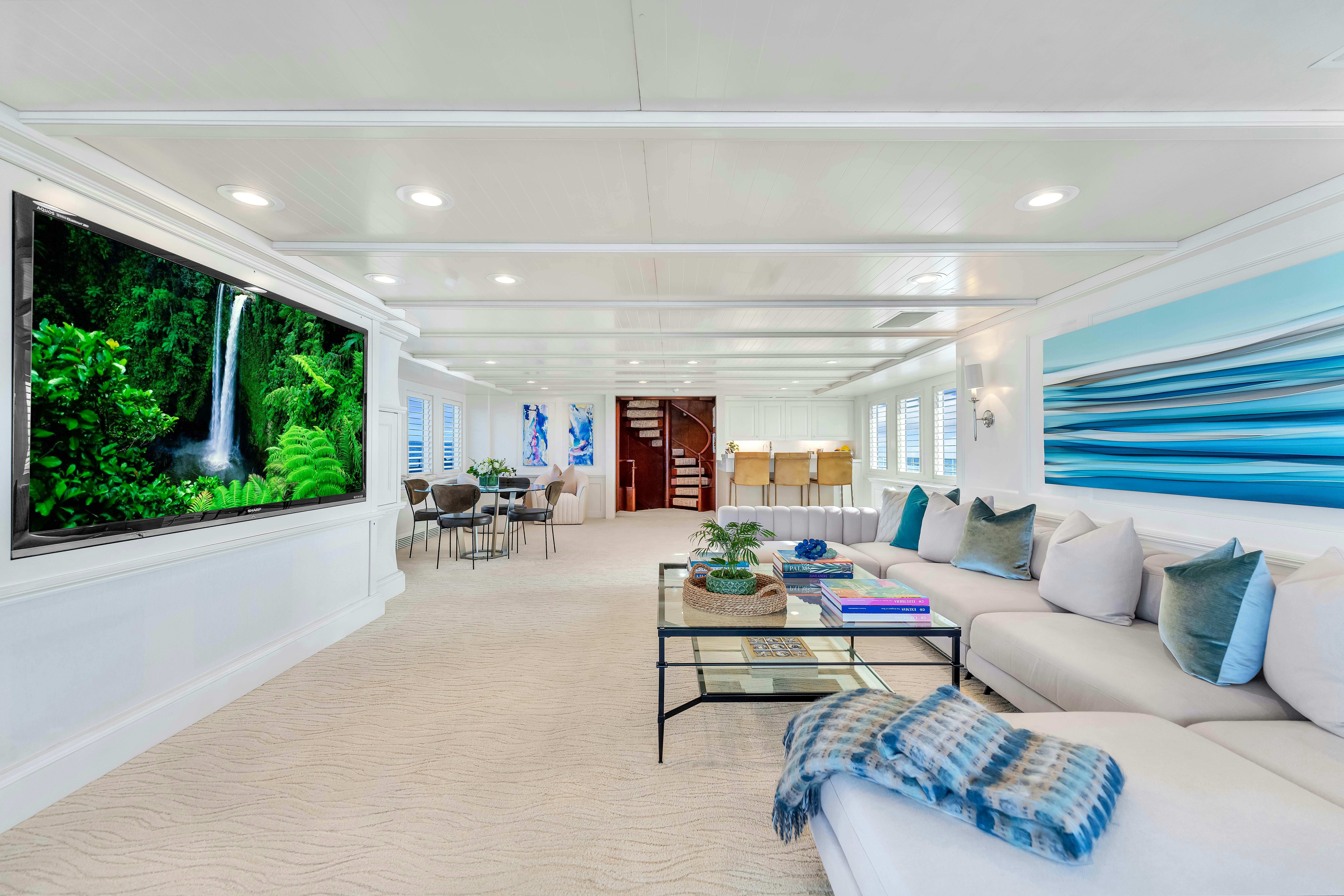 a living room with a large screen aboard STAR DIAMOND Yacht for Charter