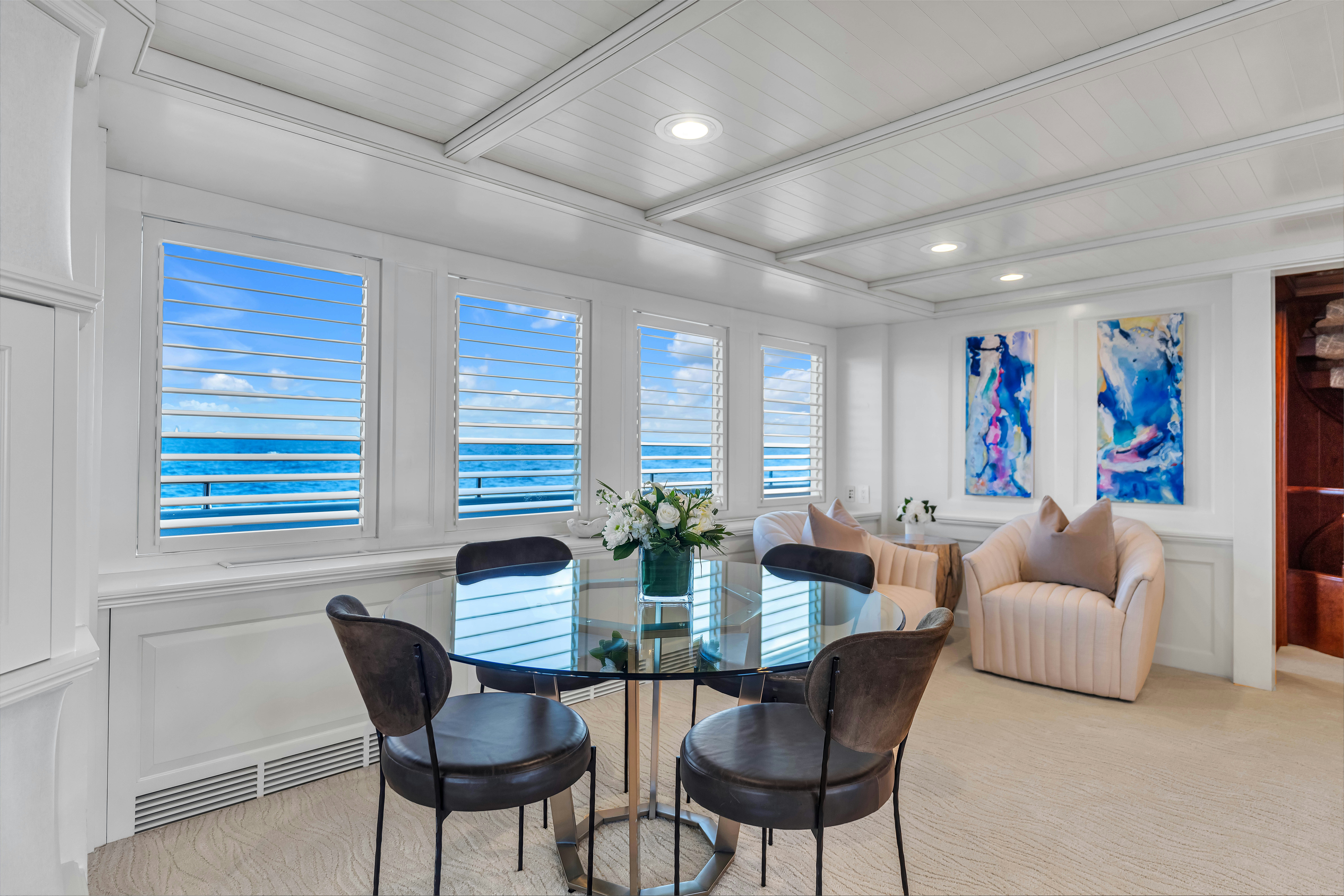 a living room with a table and chairs aboard STAR DIAMOND Yacht for Charter