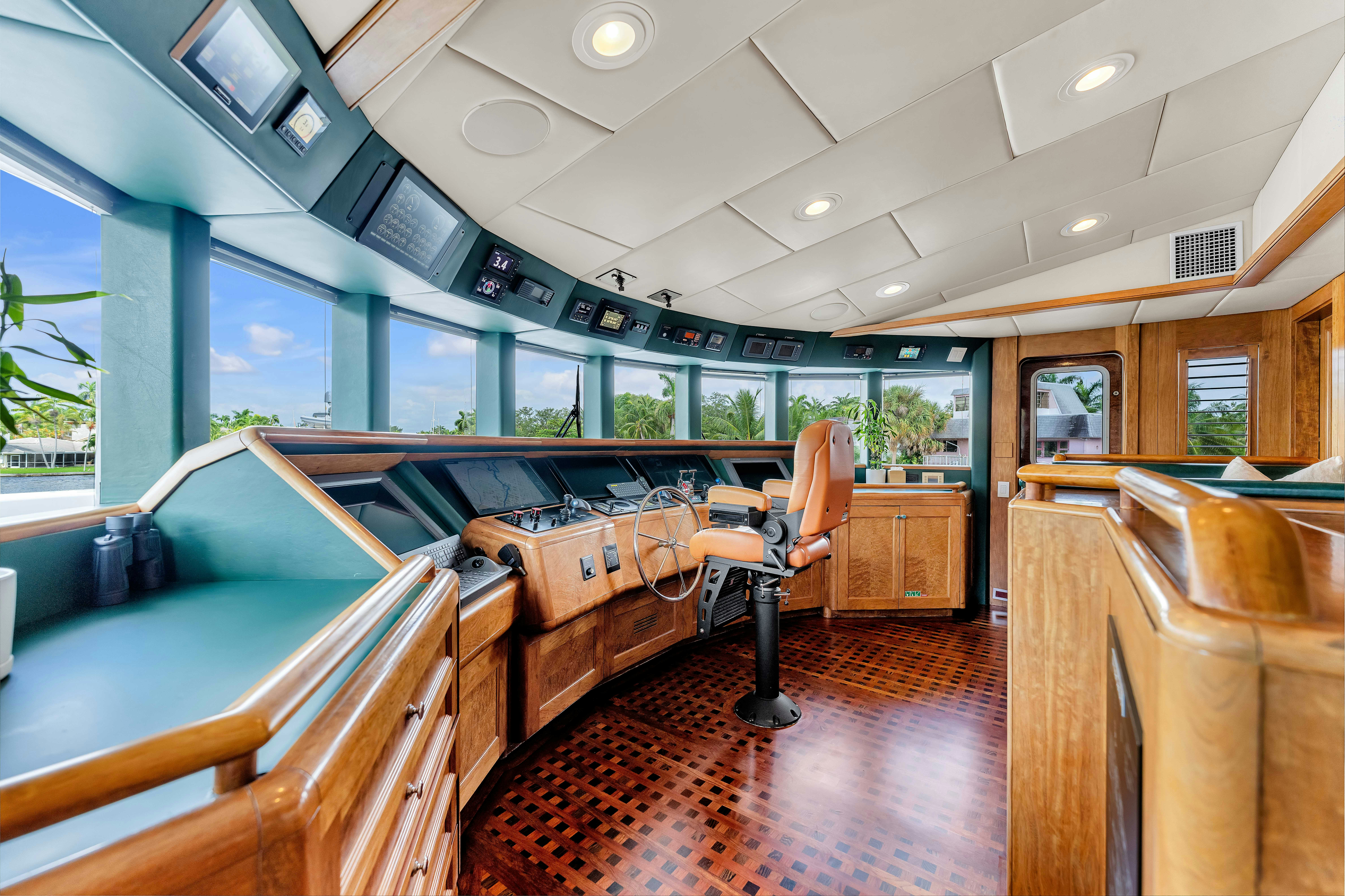 inside of a building with a large window and a table and chairs aboard STAR DIAMOND Yacht for Charter
