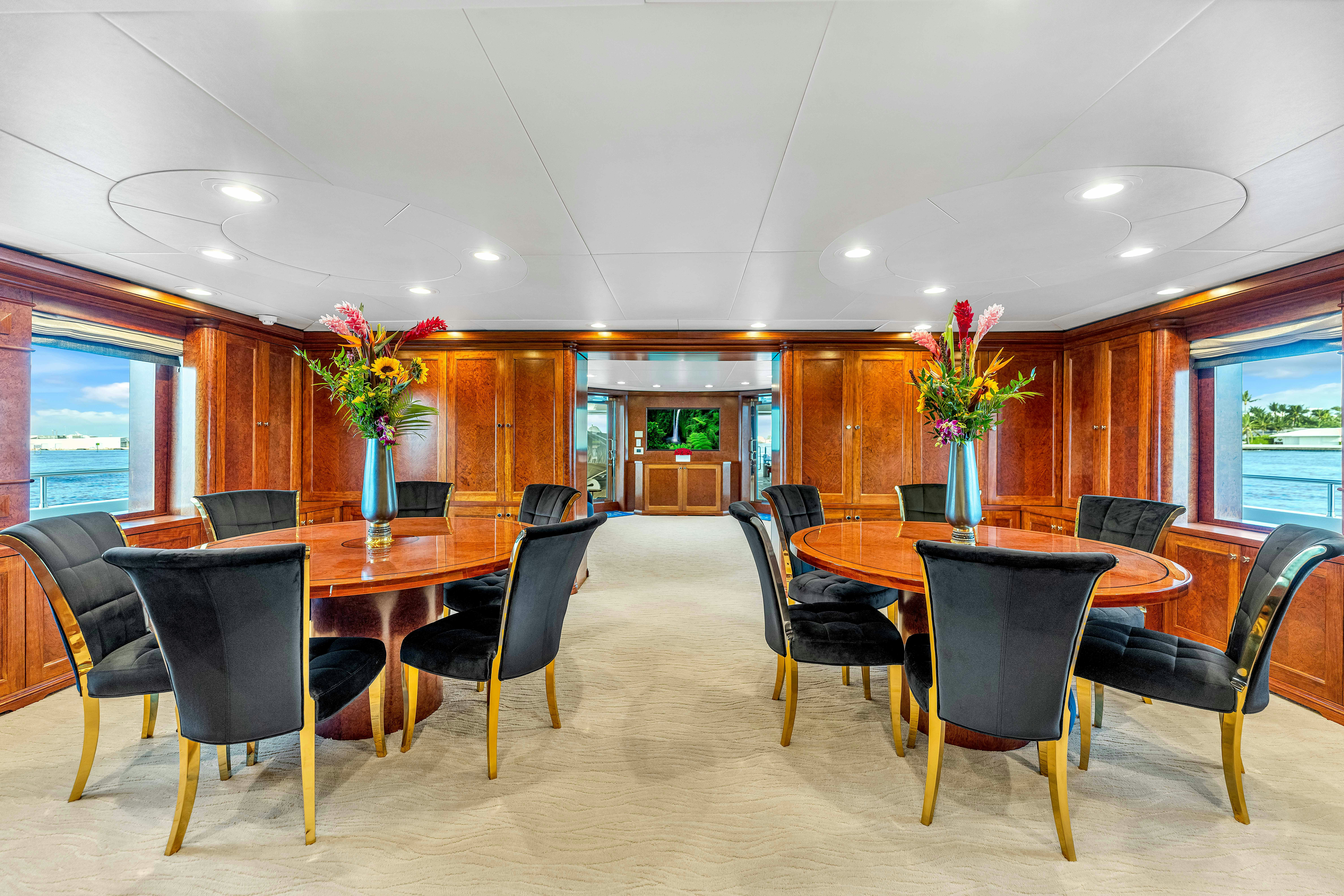 a large room with a table and chairs aboard STAR DIAMOND Yacht for Charter