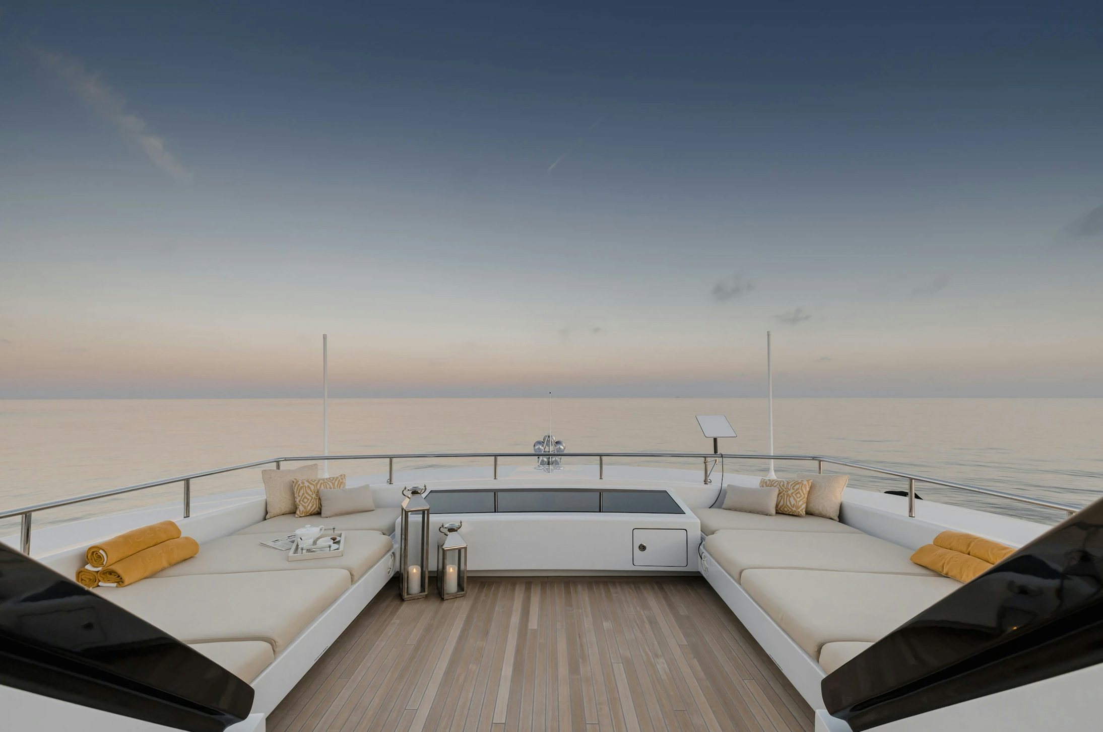 a room with a bed and a table on the deck aboard LOON Yacht for Charter