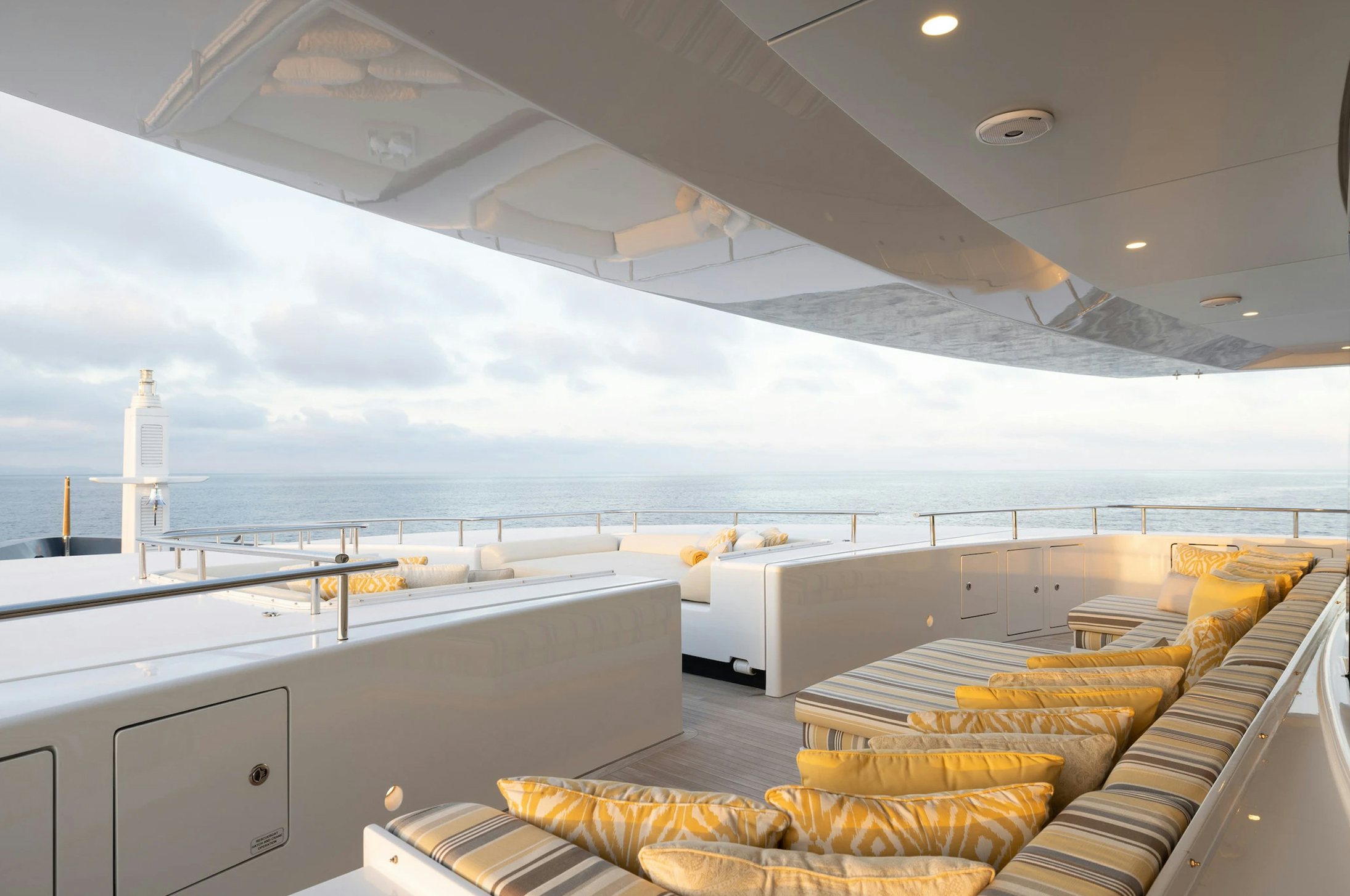 a room with a view of the ocean and the deck aboard LOON Yacht for Charter