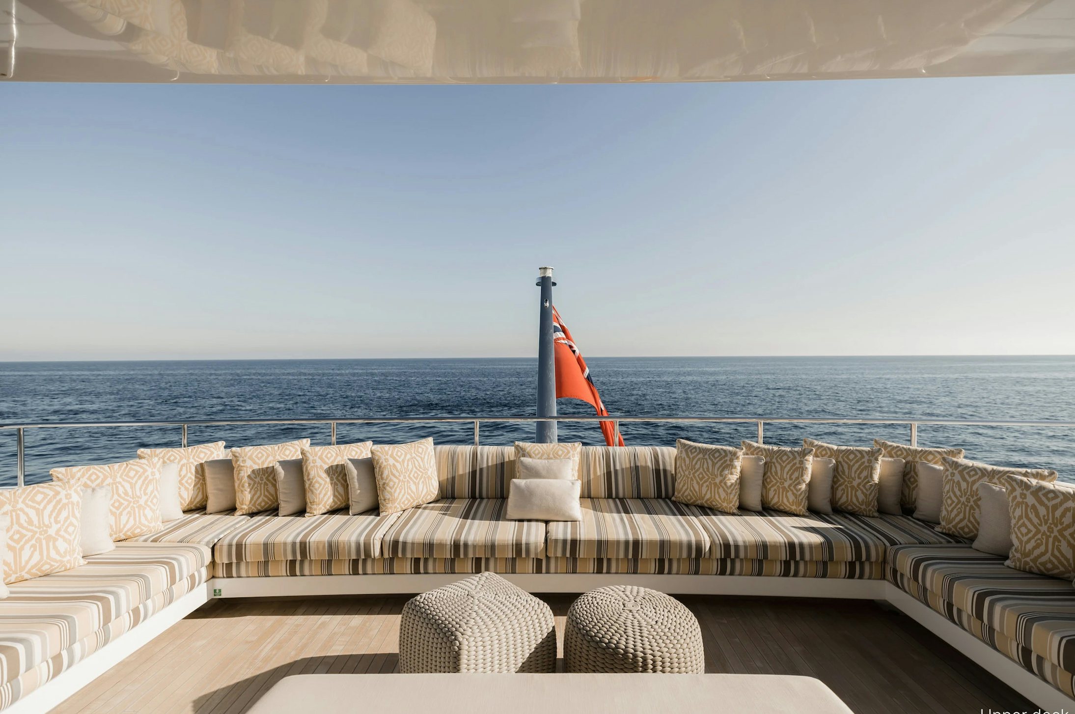 a couch with pillows on it aboard LOON Yacht for Charter