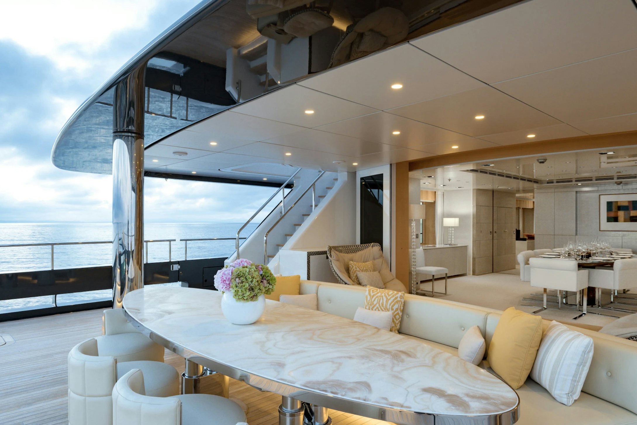 a large living room with a large balcony aboard LOON Yacht for Charter