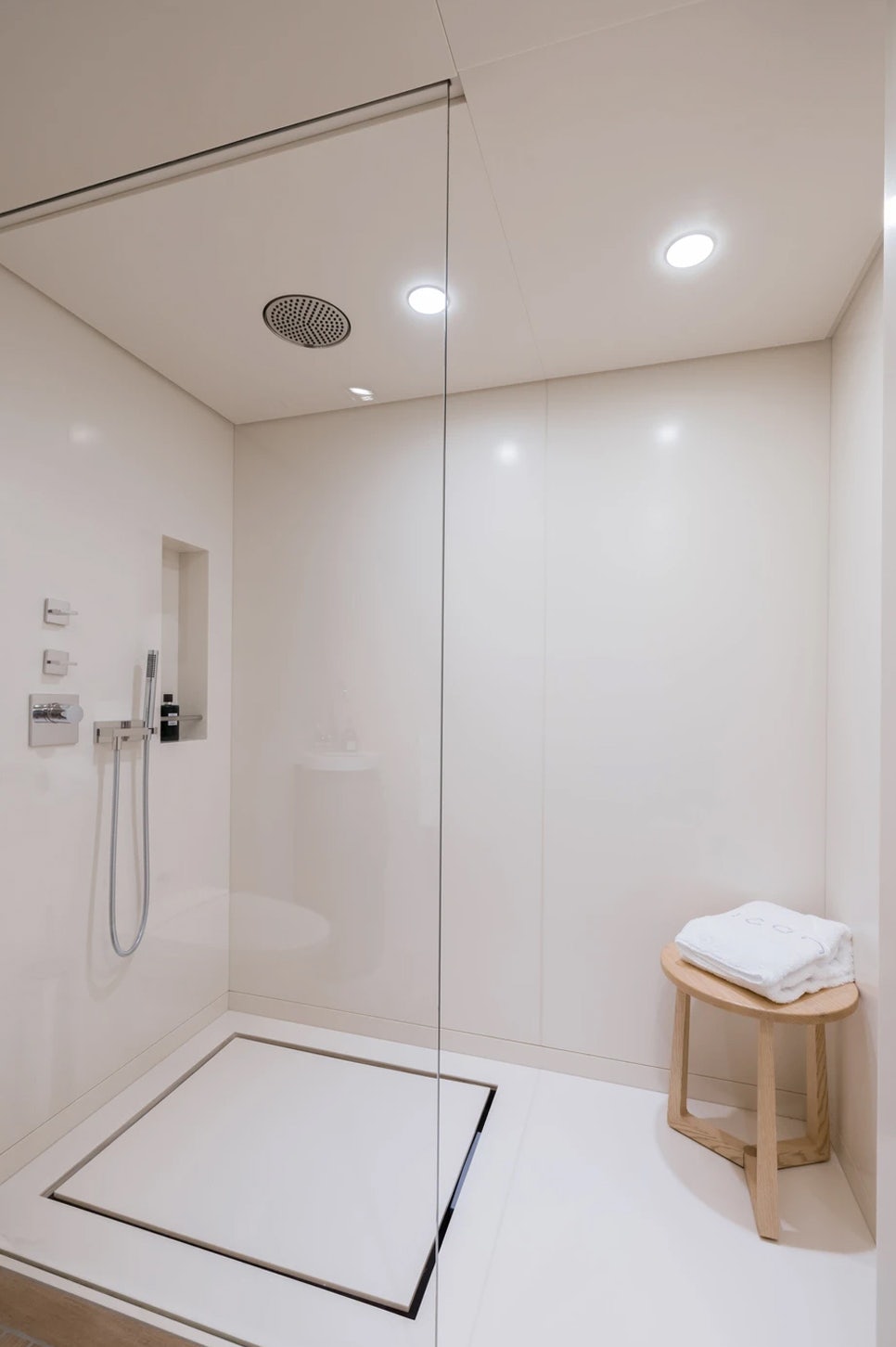 a white bathroom with a stand up shower aboard LOON Yacht for Charter