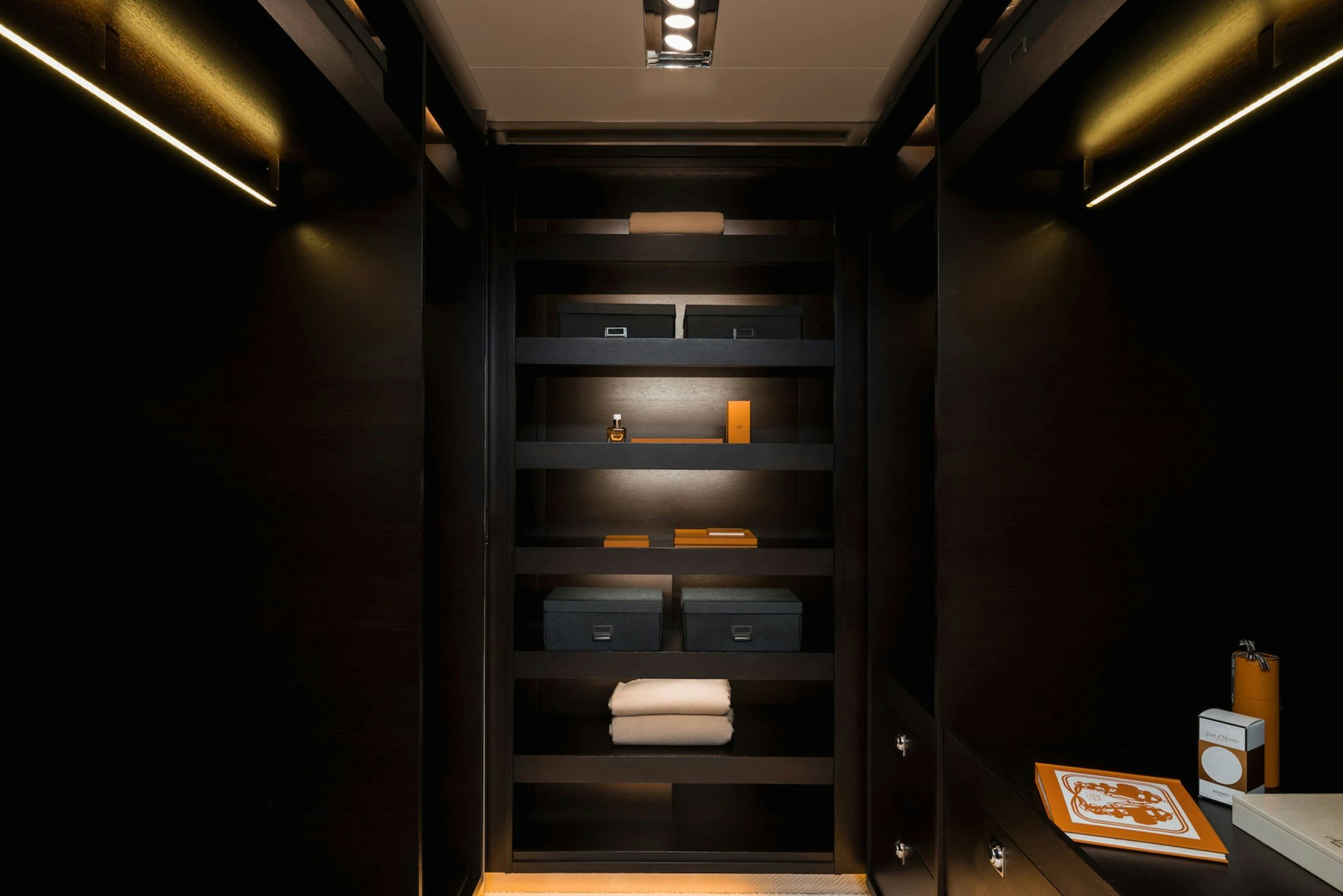 a black cabinet with a white box and a black door aboard LOON Yacht for Charter