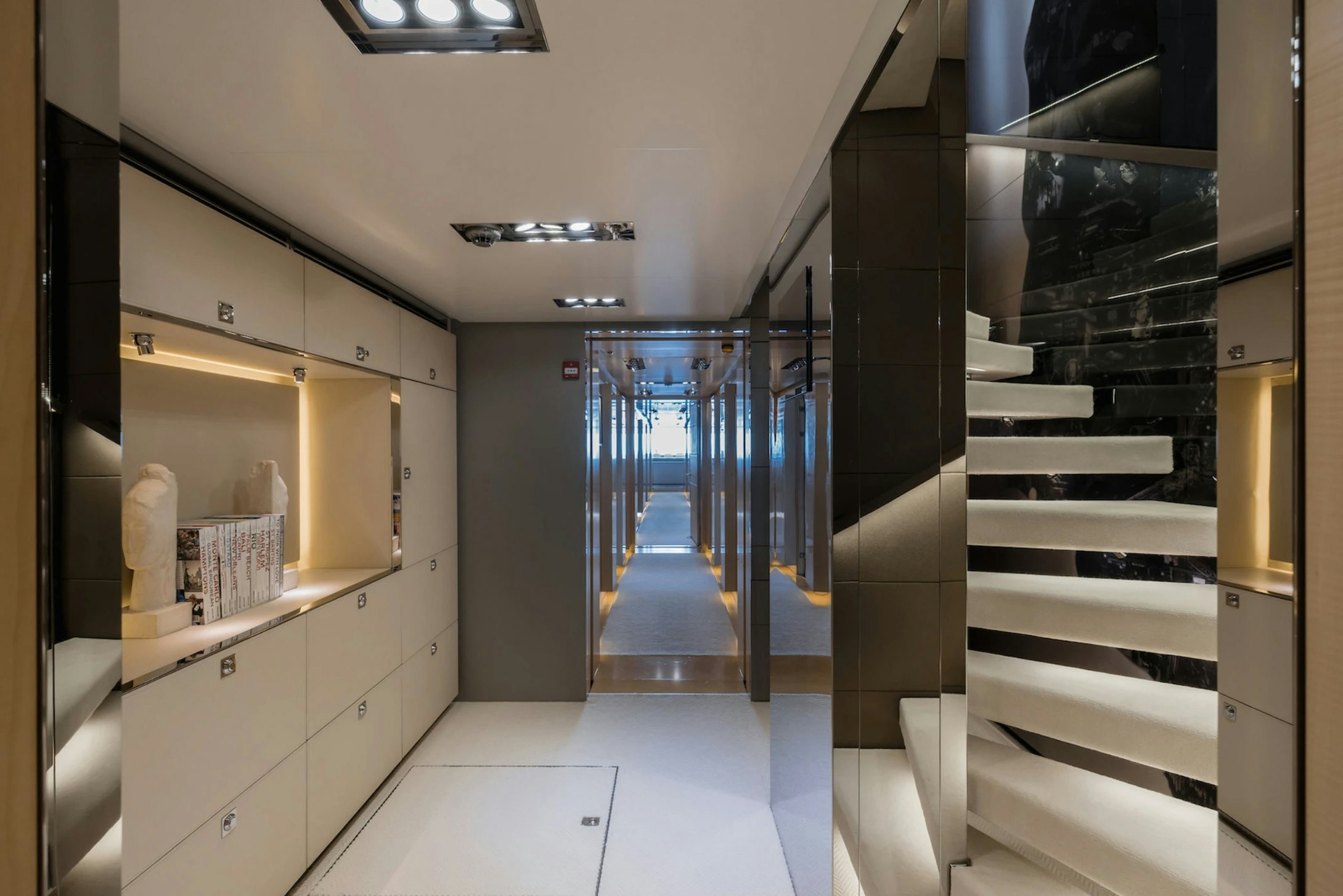 a room with a glass door and a white counter and cabinets aboard LOON Yacht for Charter