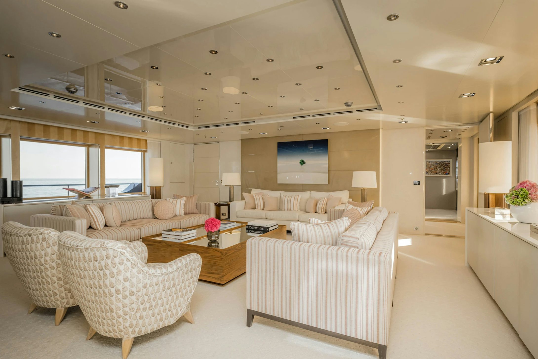a living room with white couches aboard LOON Yacht for Charter