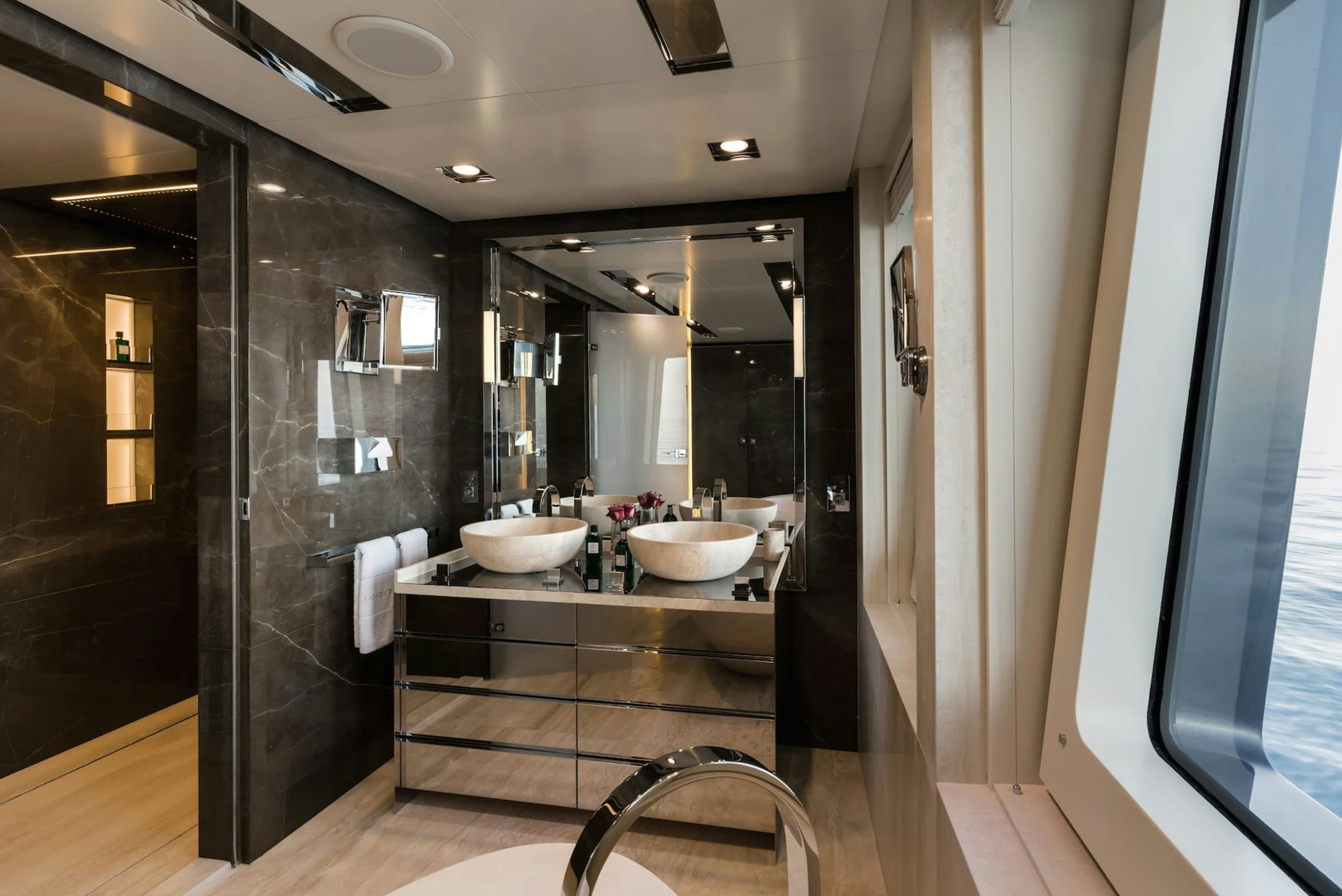 a bathroom with a large mirror aboard LOON Yacht for Charter