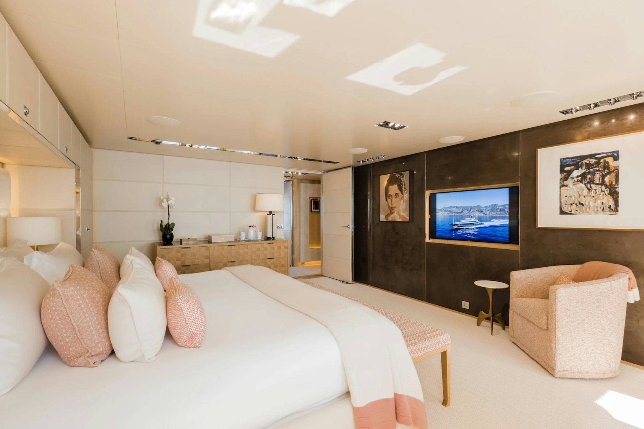 a large bedroom with a large tv aboard LOON Yacht for Charter