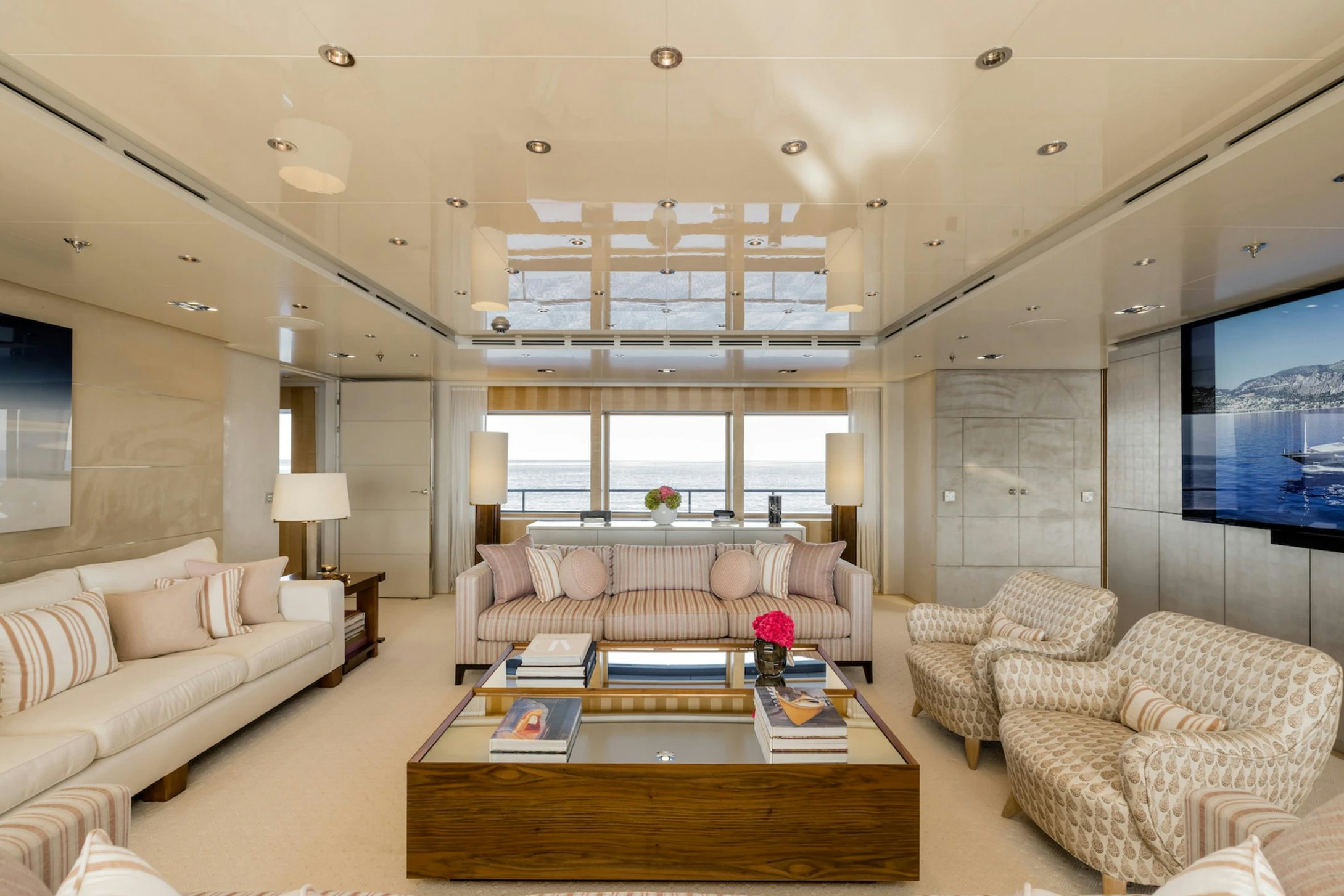 a living room with a large window aboard LOON Yacht for Charter