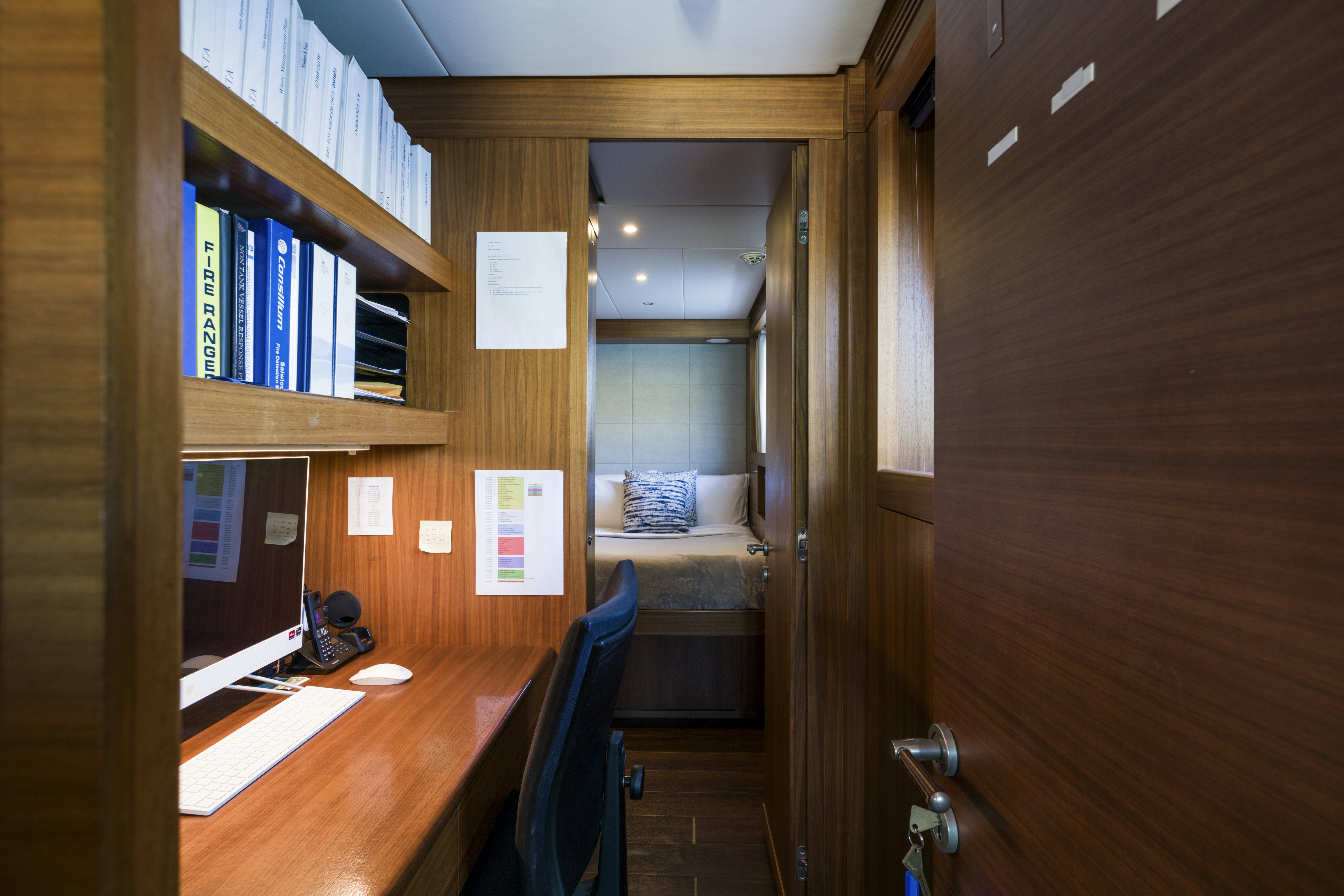 a room with a desk and a bed aboard BALISTA Yacht for Sale