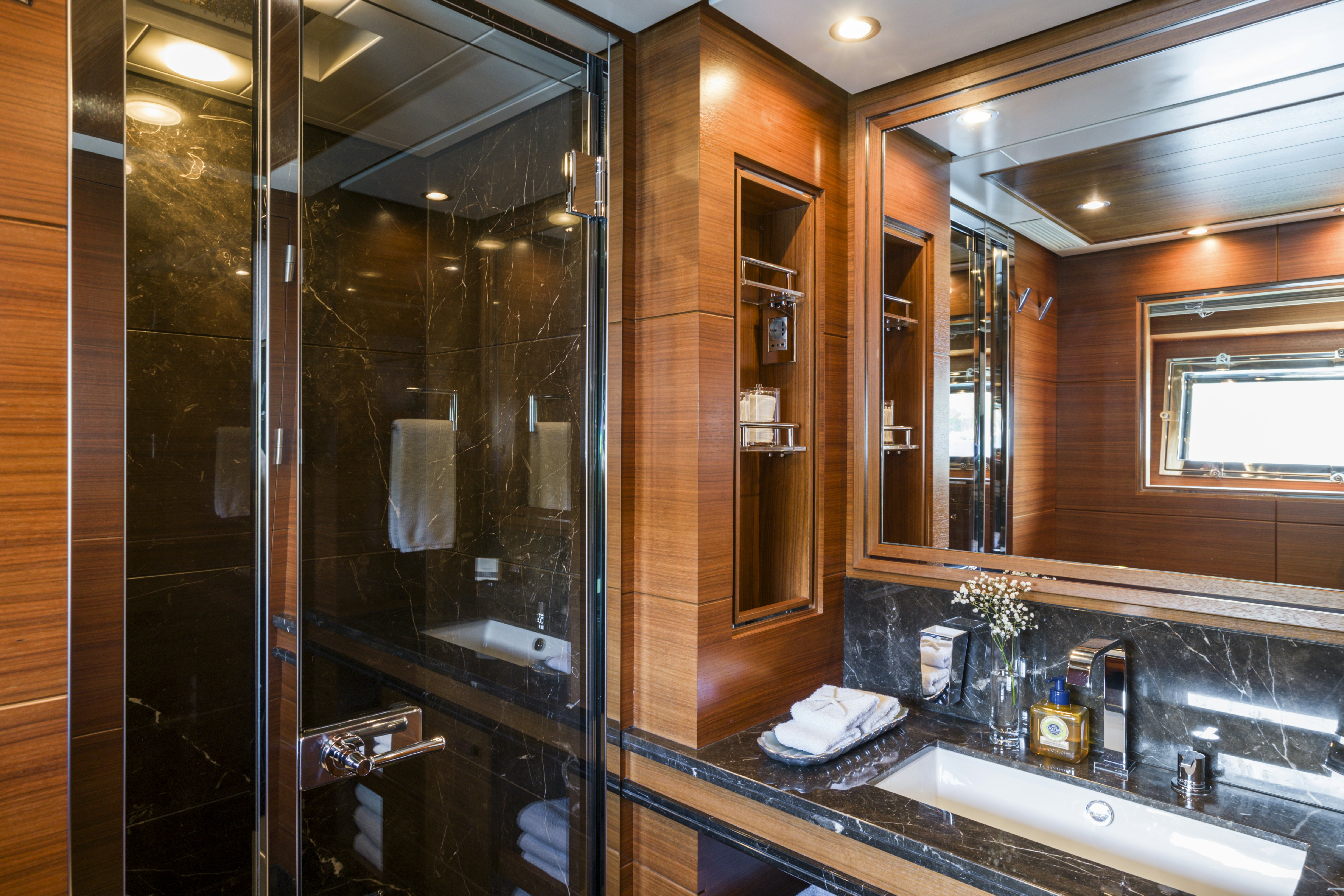 a bathroom with a glass shower aboard BALISTA Yacht for Sale