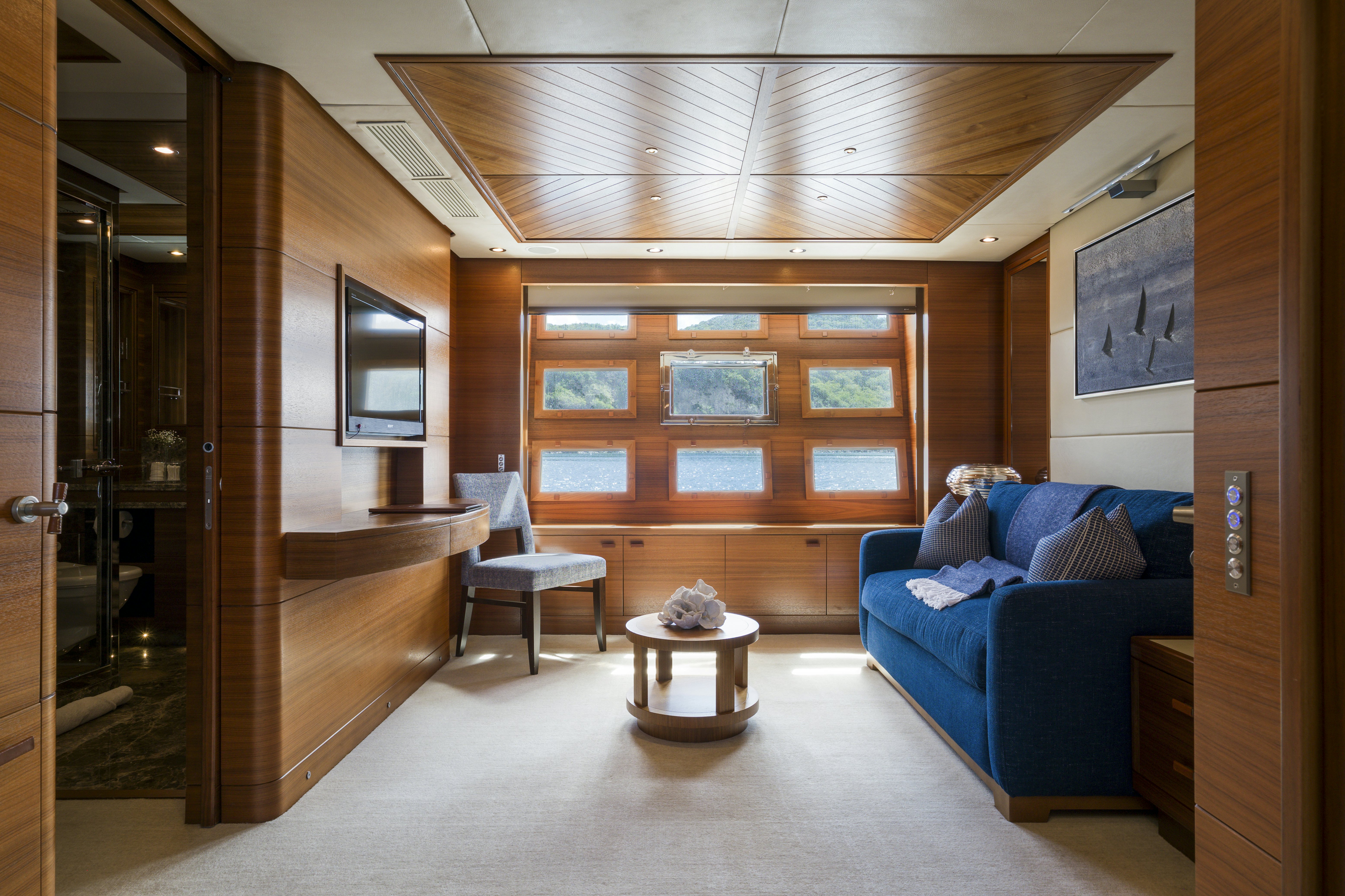 a person sitting on a couch in a room with a wood wall aboard BALISTA Yacht for Sale