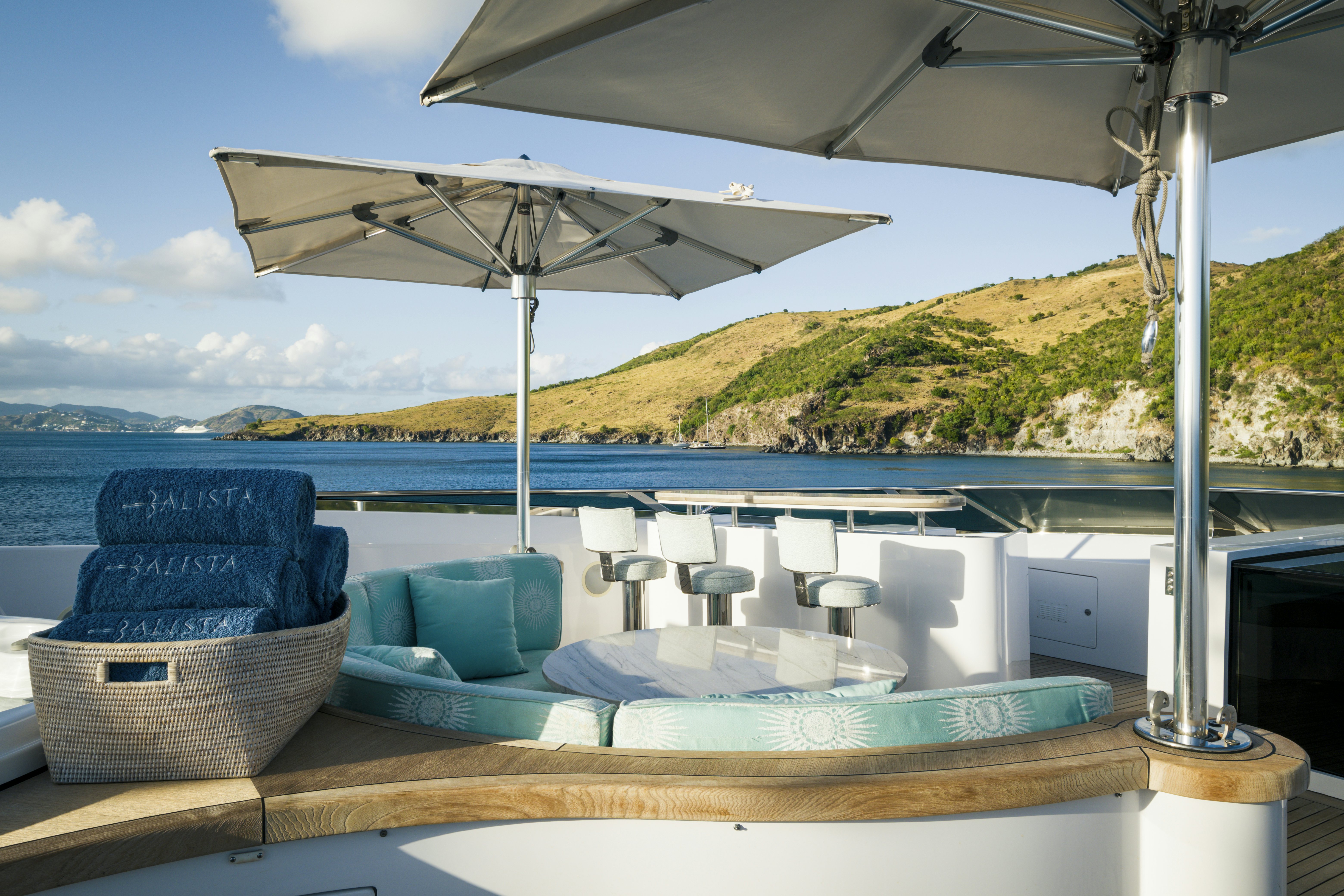 a lounge area with a large umbrella aboard BALISTA Yacht for Sale