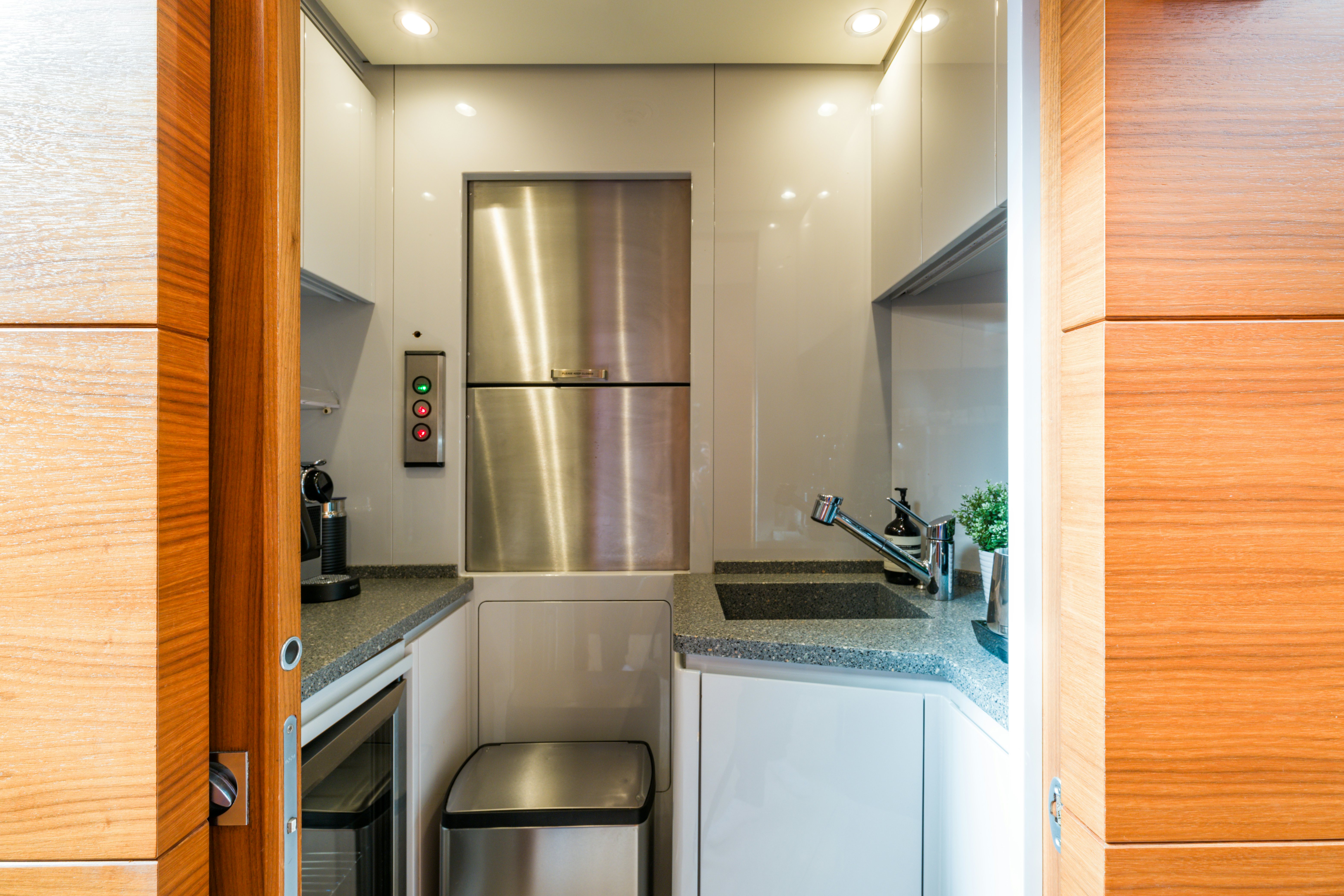 a kitchen with a stainless steel refrigerator aboard BALISTA Yacht for Sale