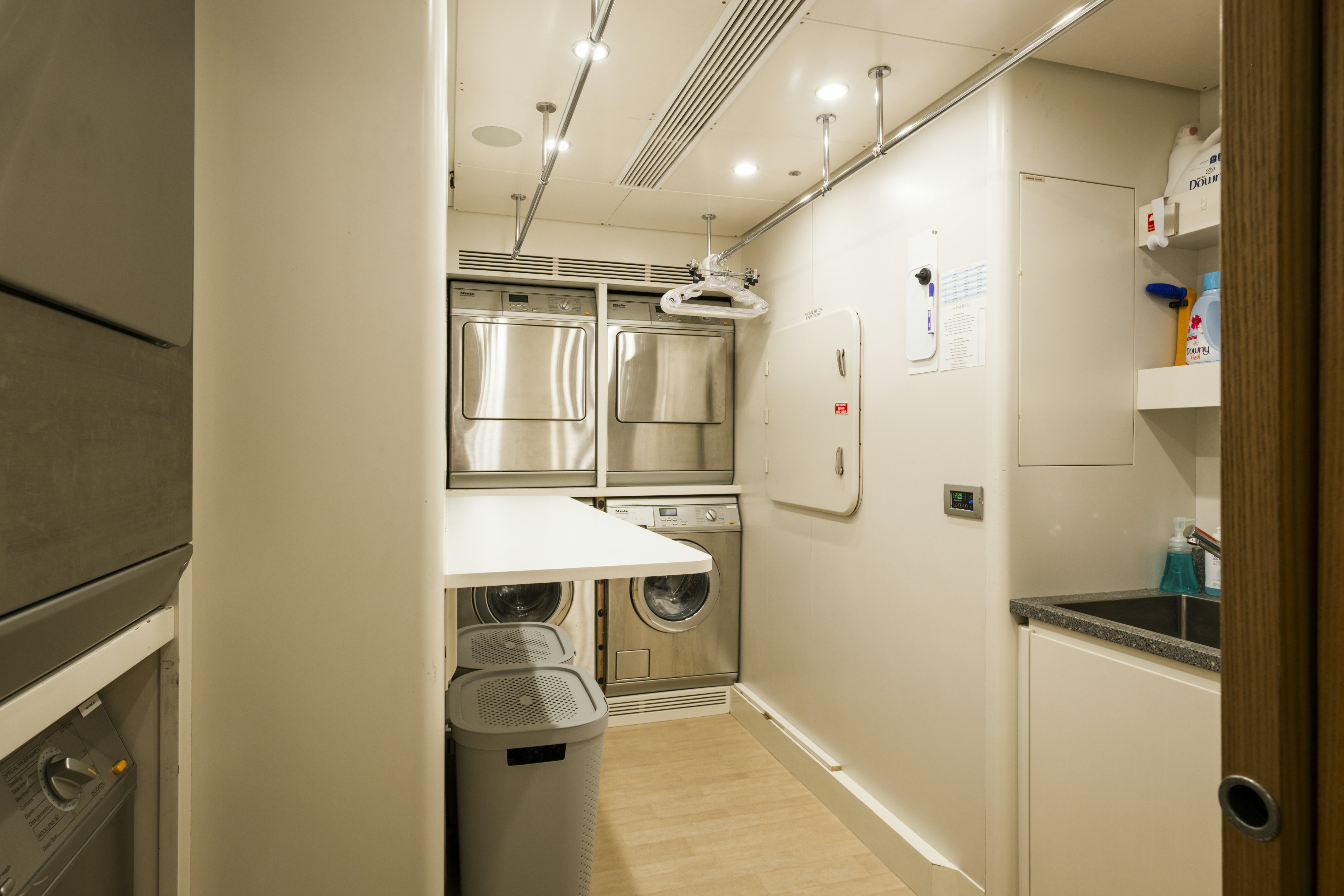 a kitchen with white cabinets aboard BALISTA Yacht for Sale
