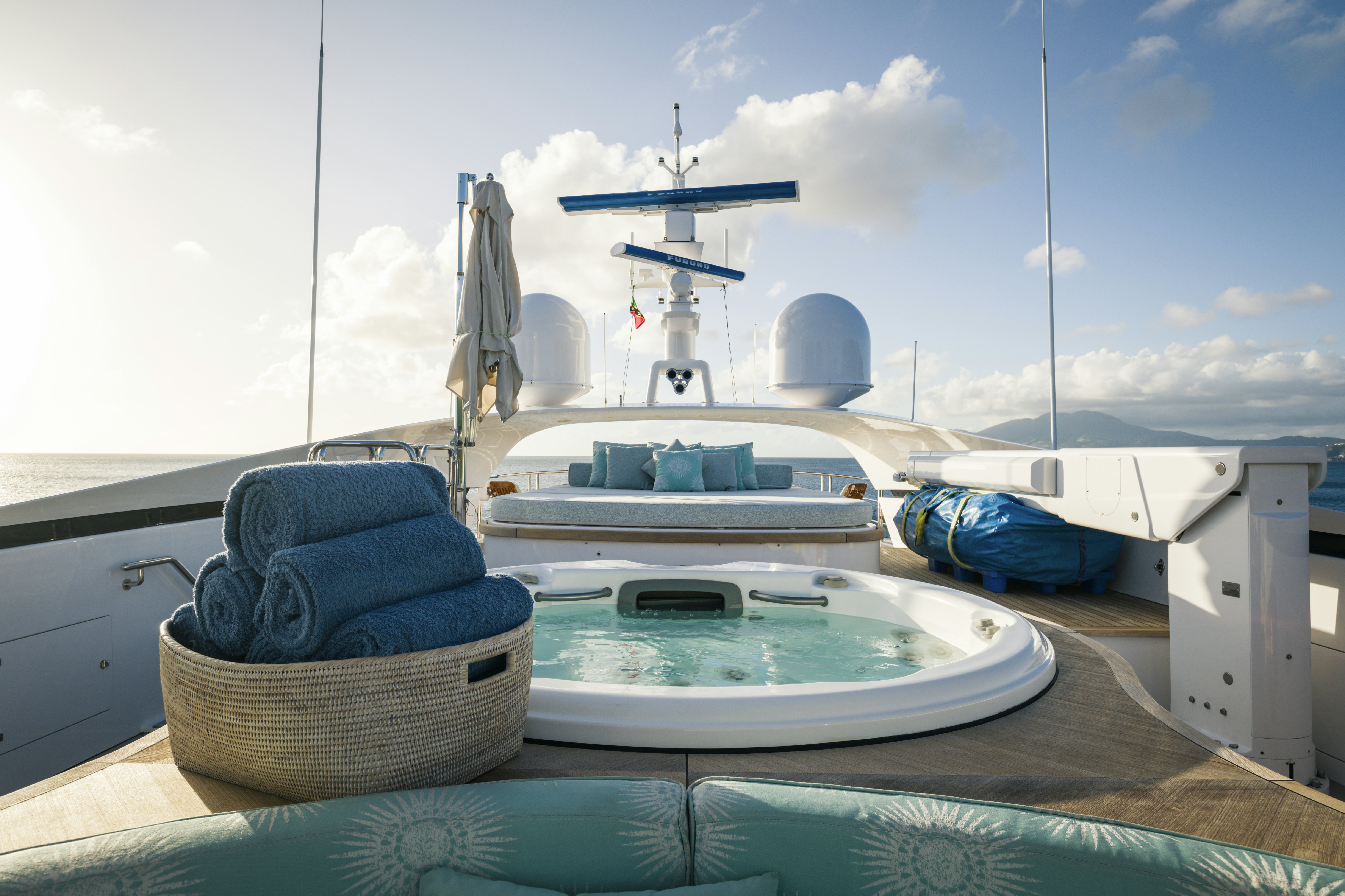 a white tub and a blue mat on a table with a white tablecloth and a white dish aboard BALISTA Yacht for Sale