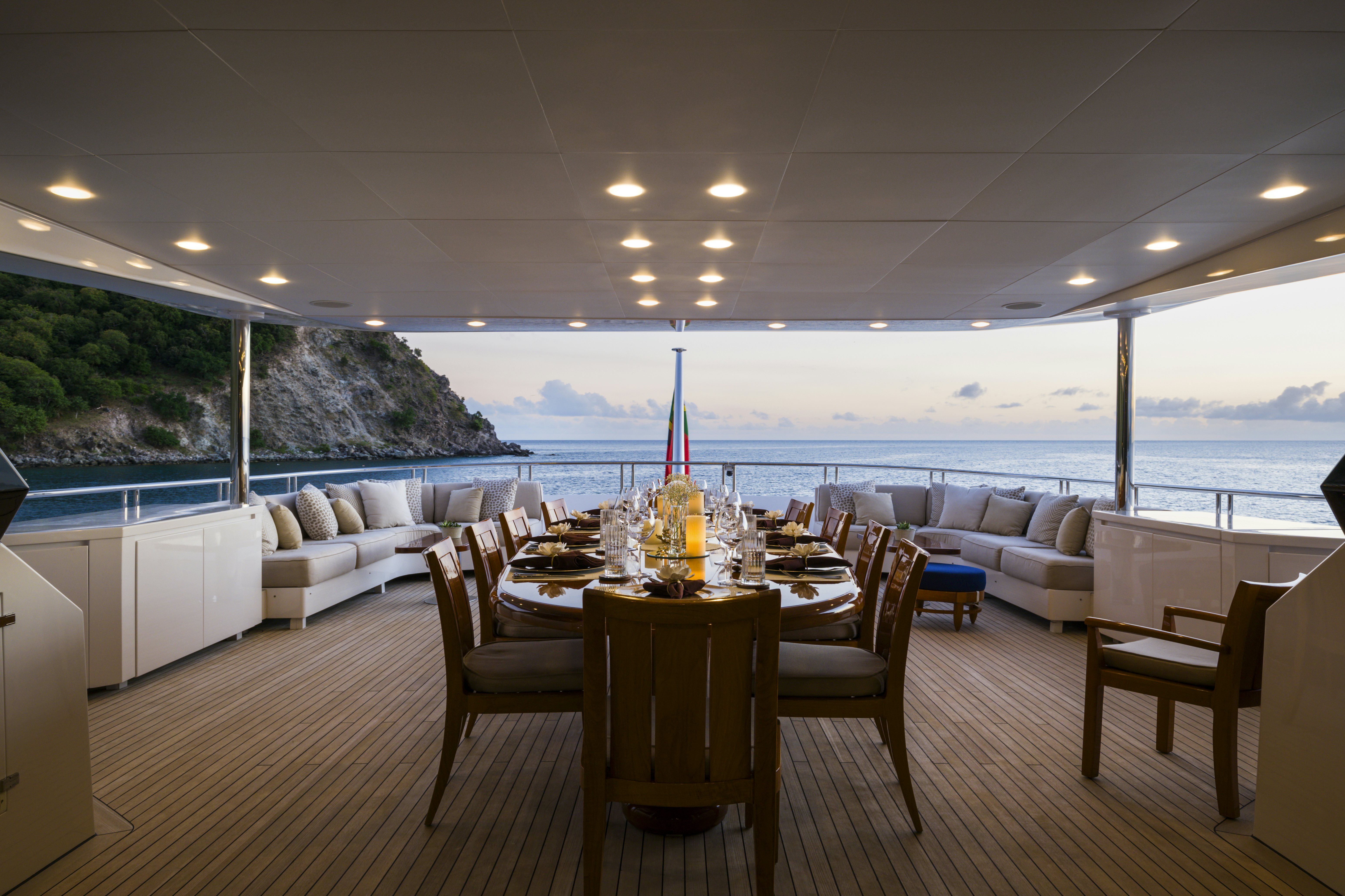 a dining table in a room with a view of the ocean aboard BALISTA Yacht for Sale