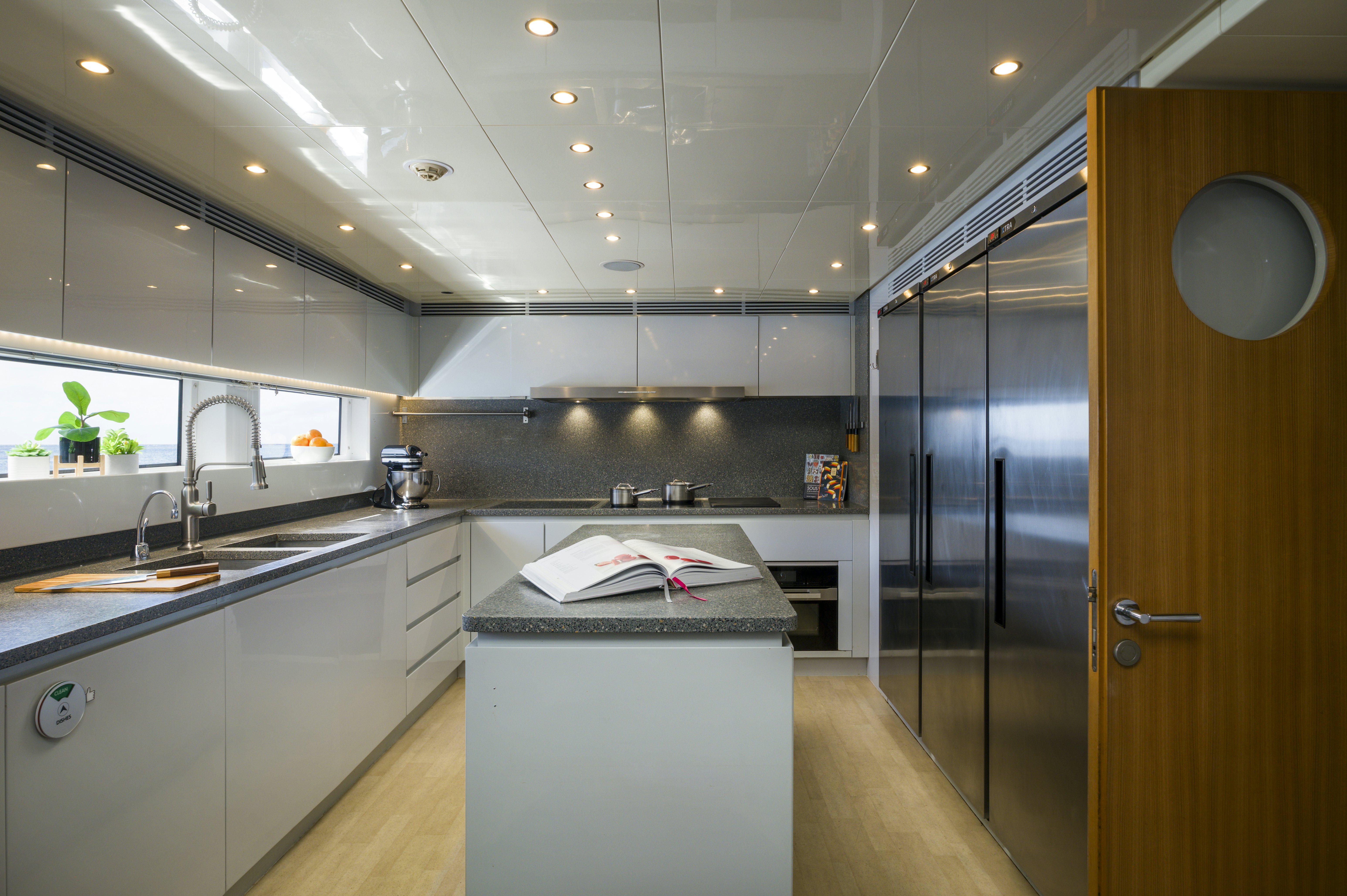 a kitchen with a sink and a refrigerator aboard BALISTA Yacht for Sale