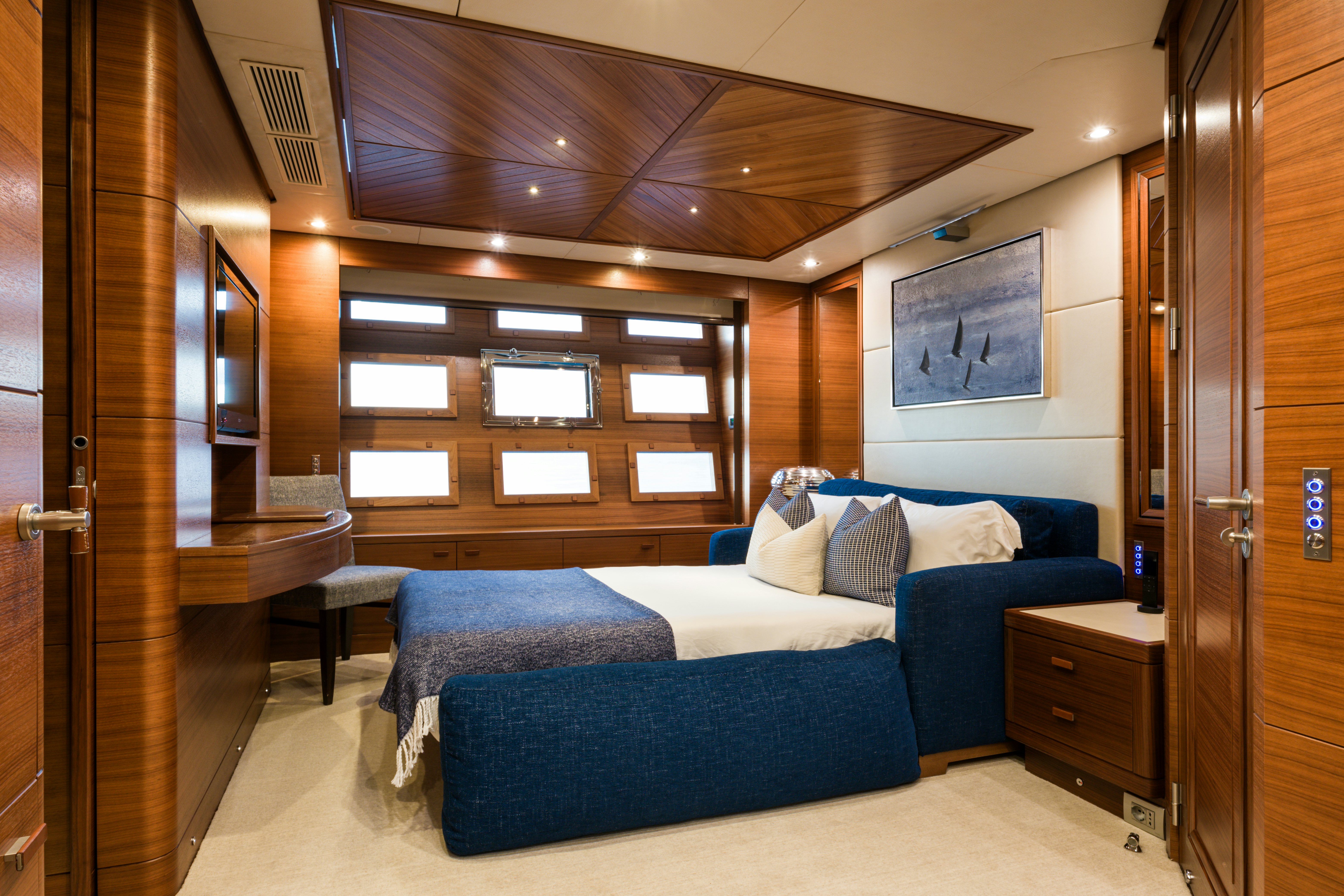 a bedroom with a bed and a desk aboard BALISTA Yacht for Sale