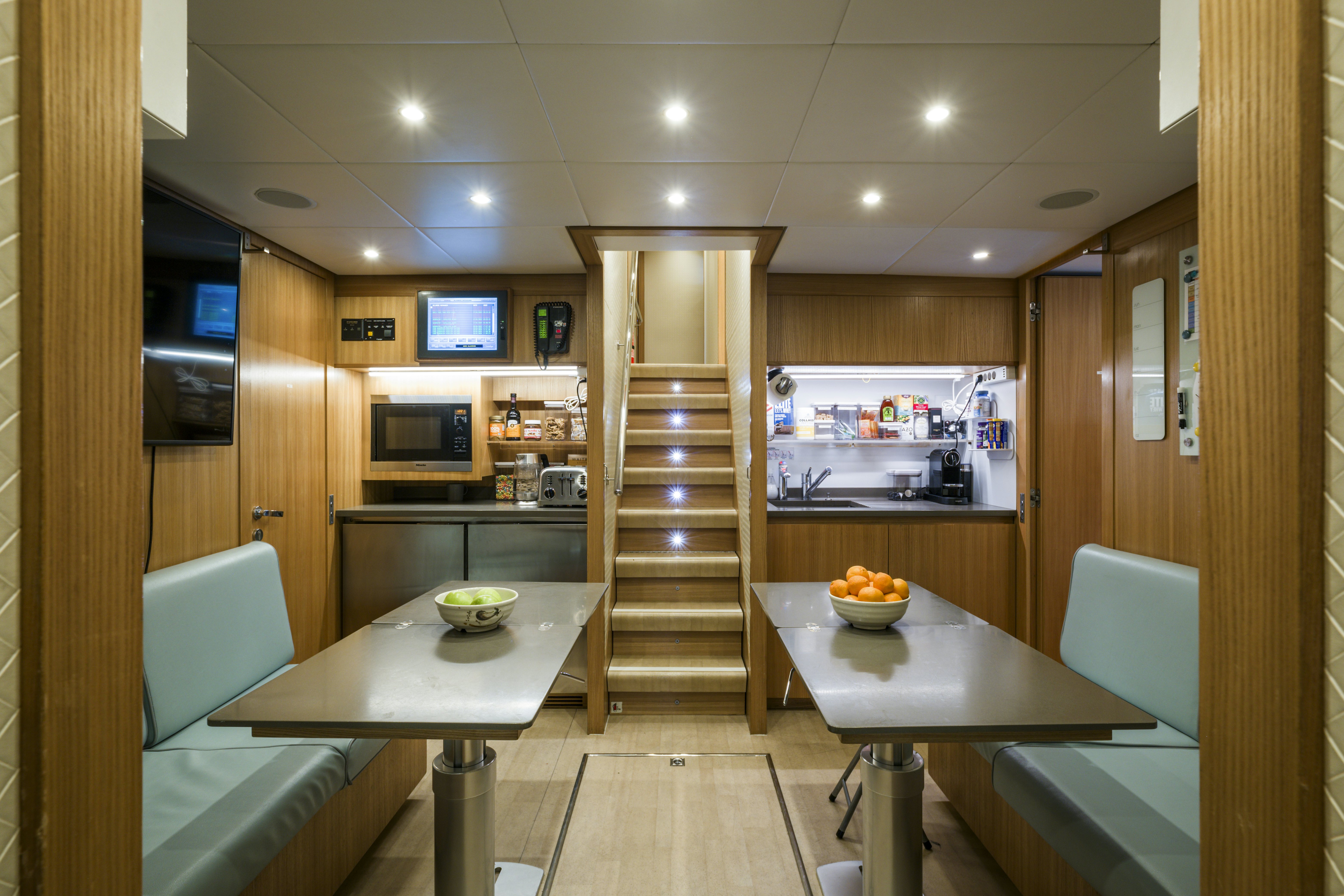 a kitchen with a wood staircase aboard BALISTA Yacht for Sale