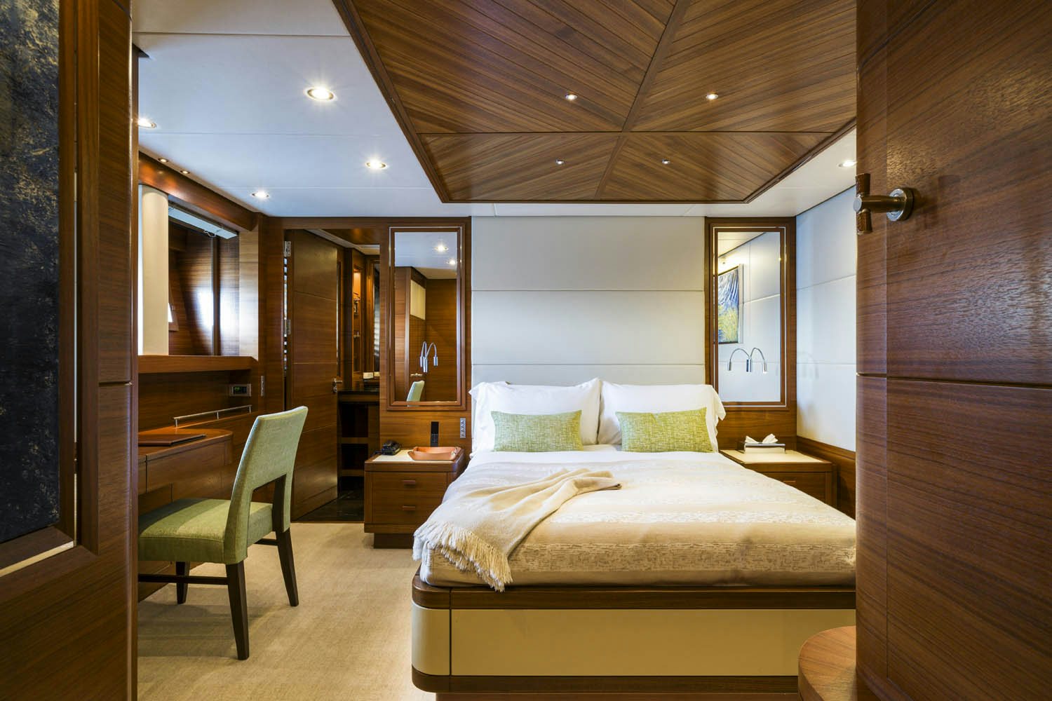 a bedroom with a bed and a chair aboard BALISTA Yacht for Charter