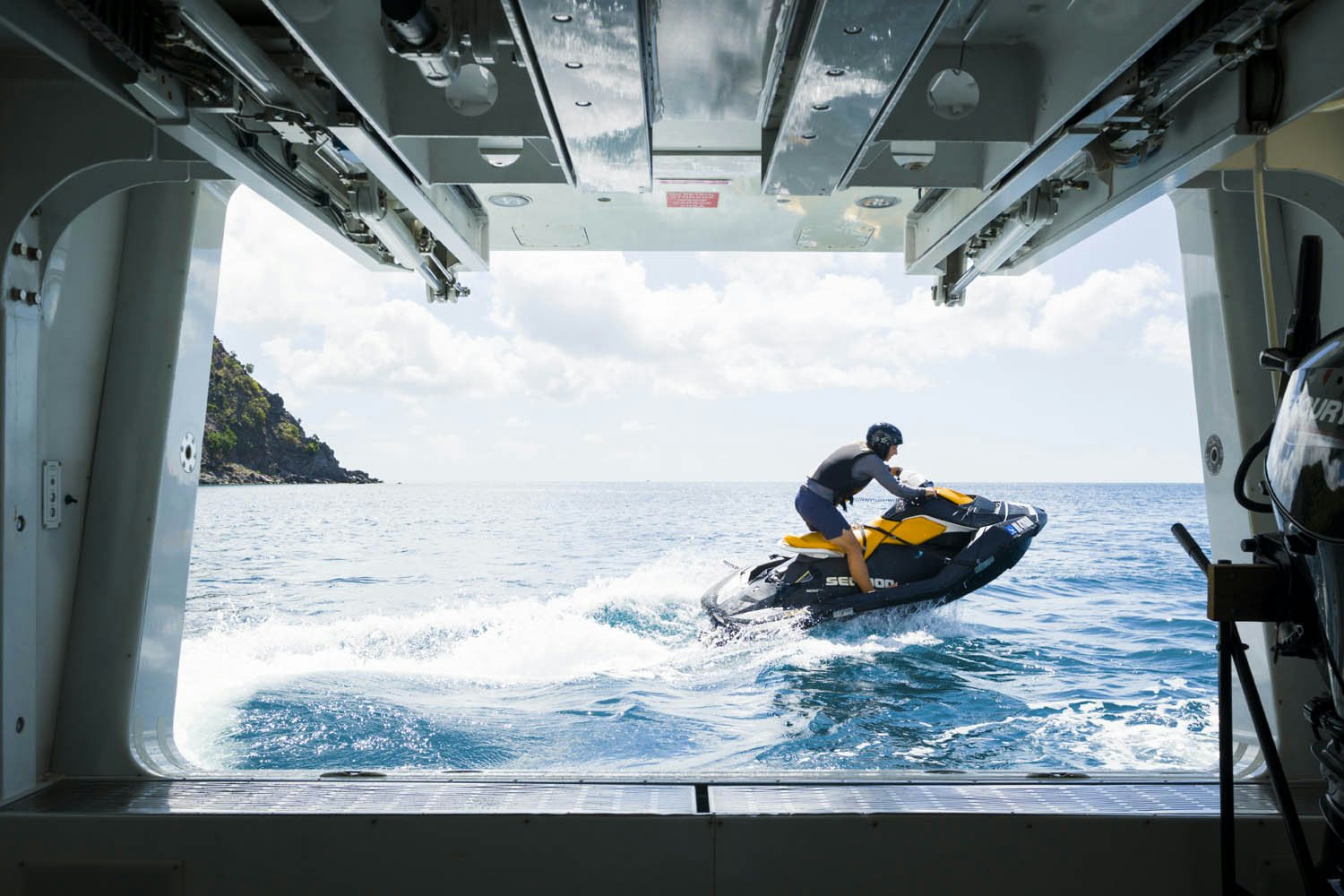 a man on a yellow kayak in the water aboard BALISTA Yacht for Charter