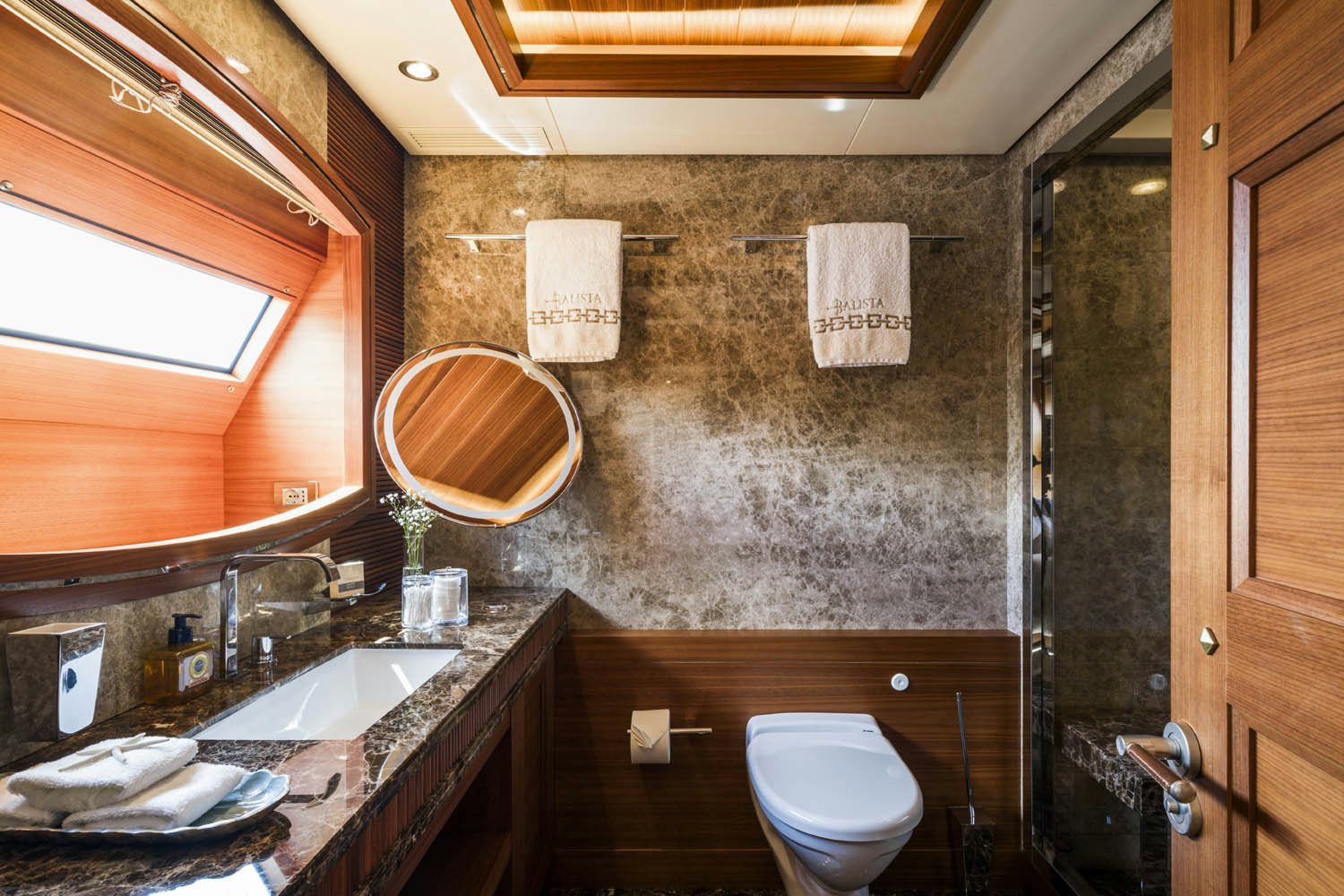 a bathroom with a toilet and sink aboard BALISTA Yacht for Charter