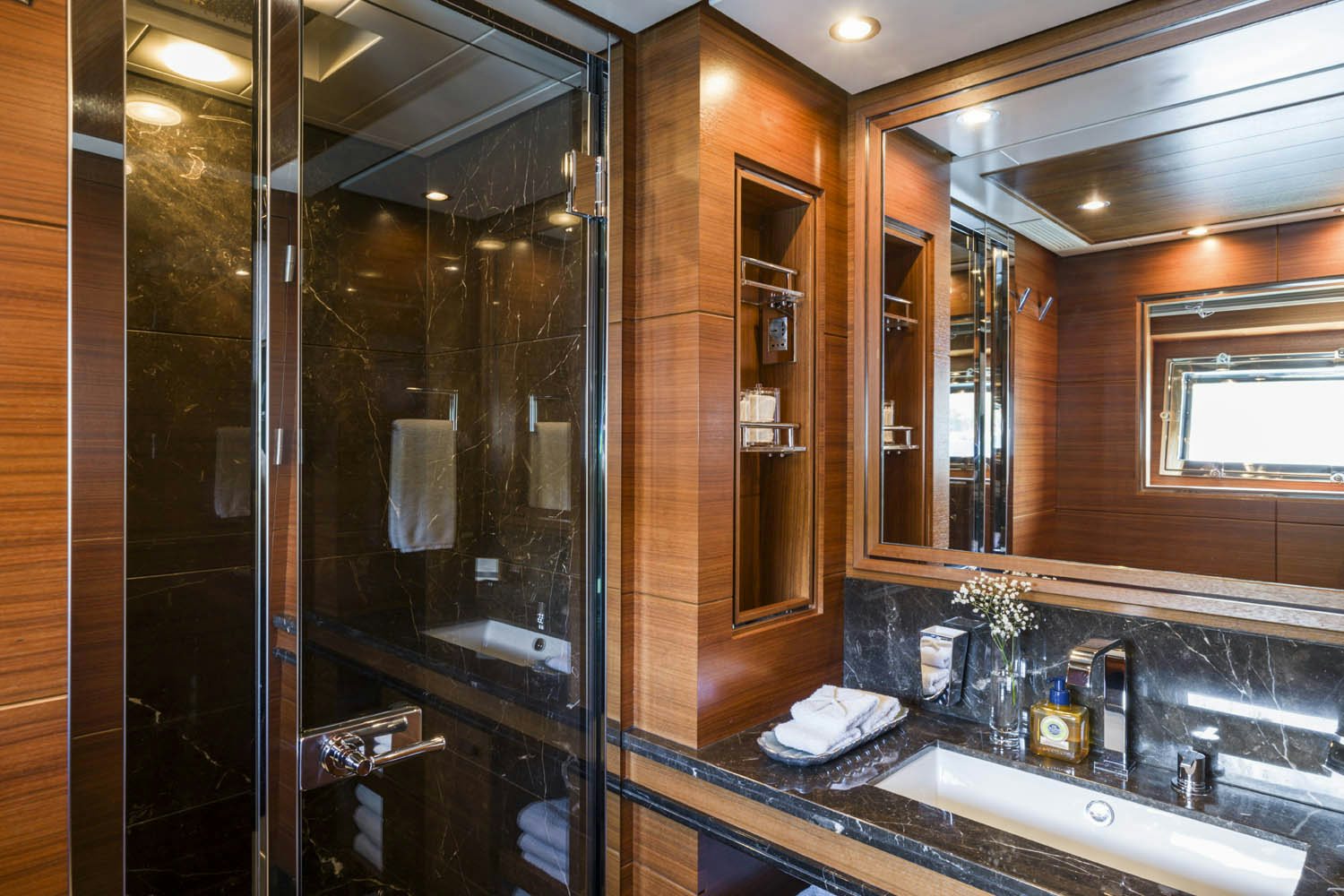 a bathroom with a glass shower aboard BALISTA Yacht for Charter