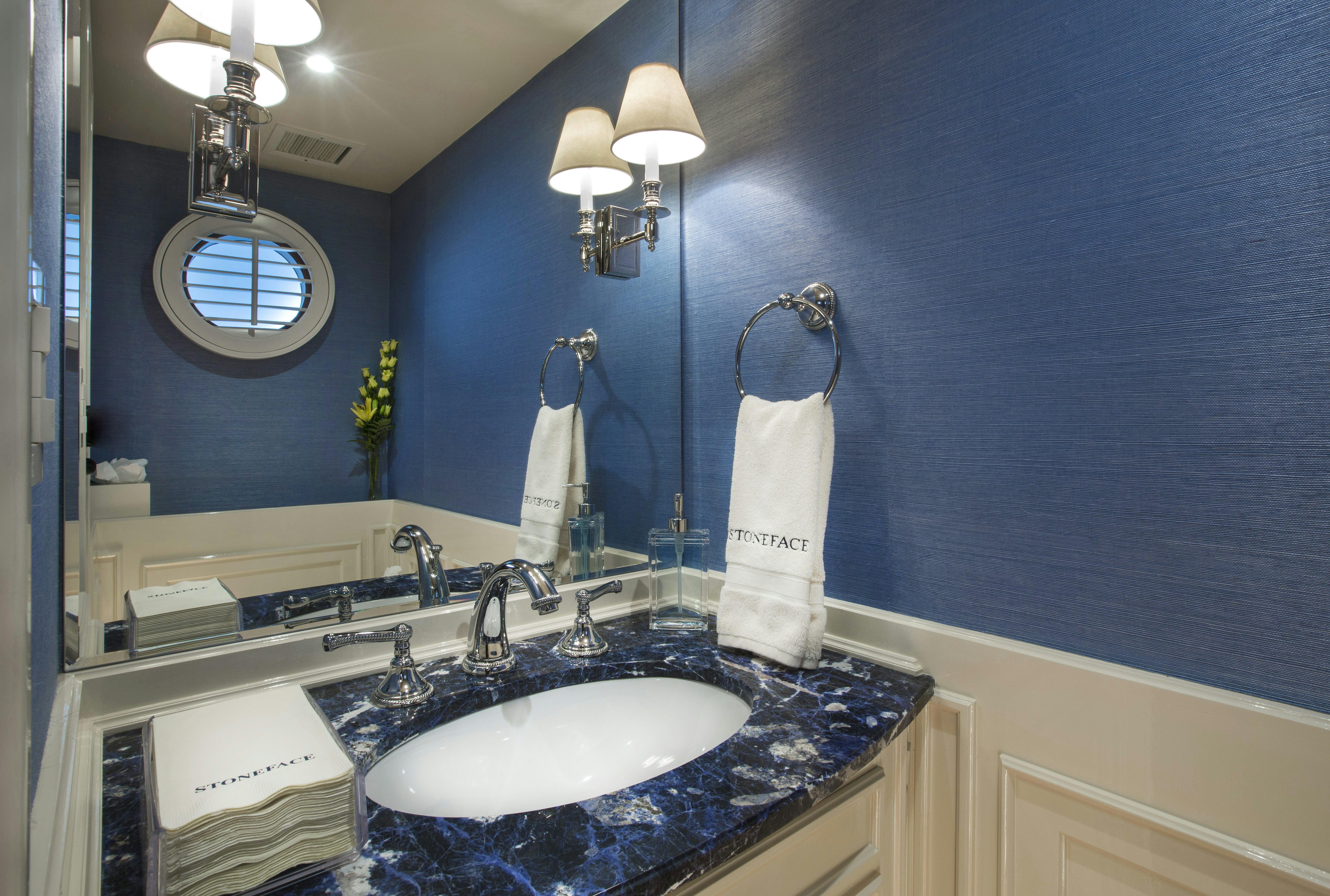 a bathroom with a sink and mirror aboard STONEFACE Yacht for Sale