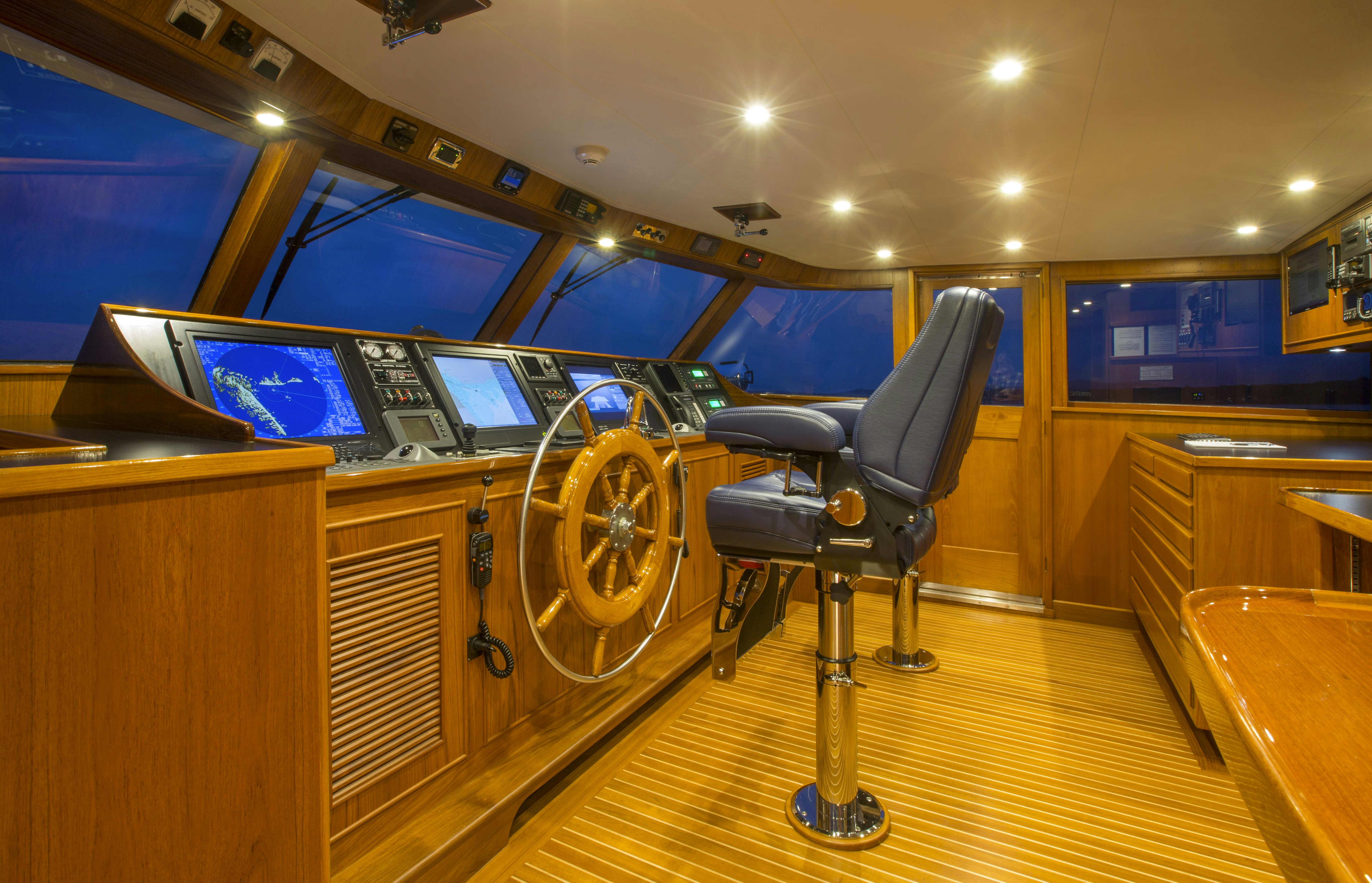 a room with a large mirror and a chair in it aboard STONEFACE Yacht for Sale