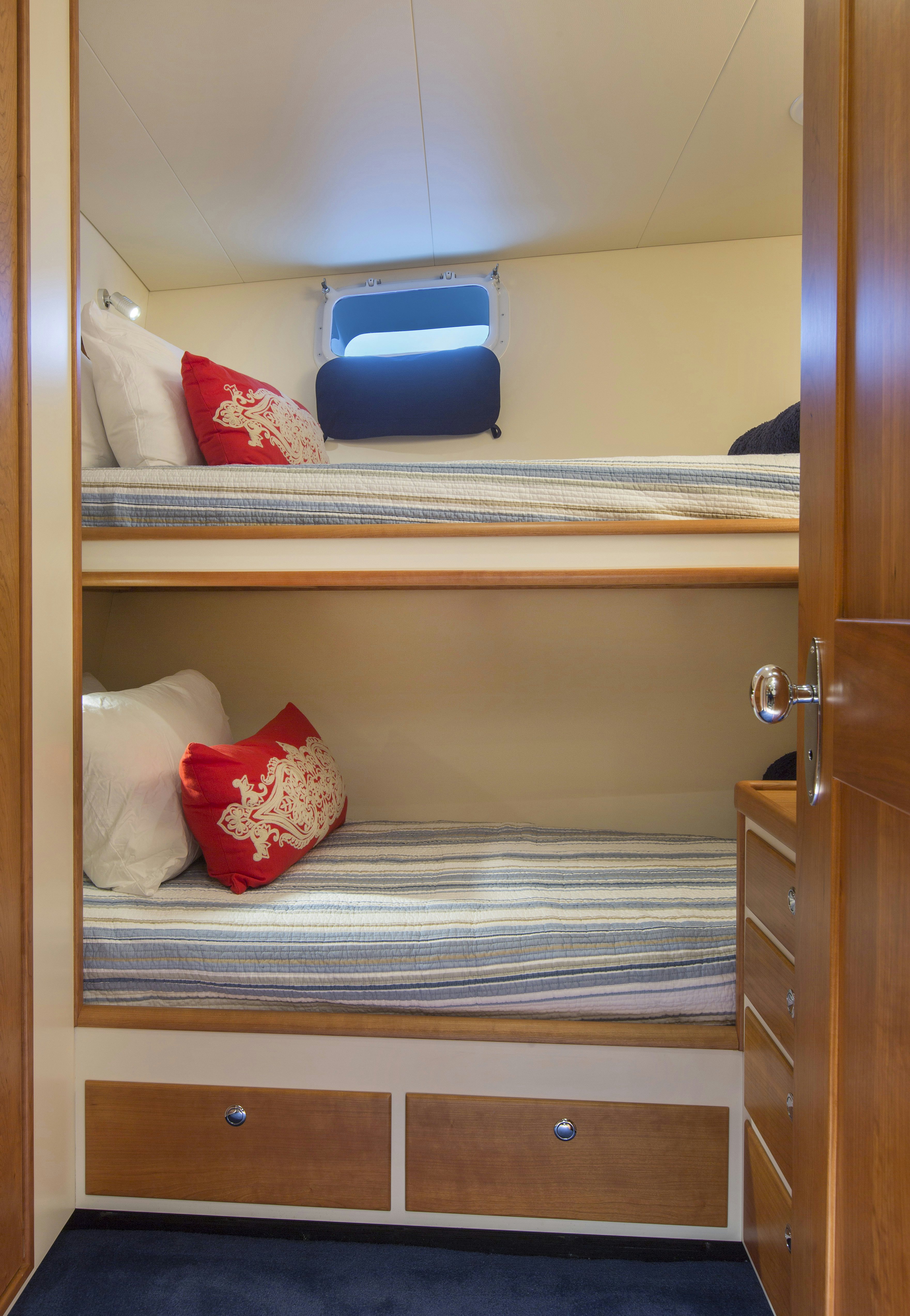 a bed with a blue pillow aboard STONEFACE Yacht for Sale