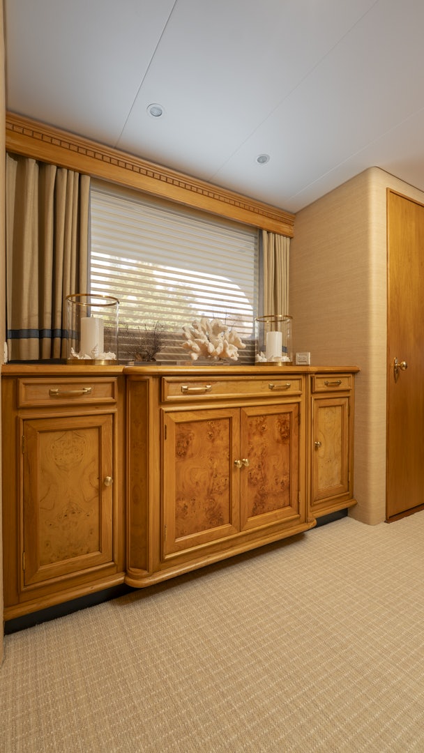 a kitchen with wooden cabinets aboard STONEFACE Yacht for Sale