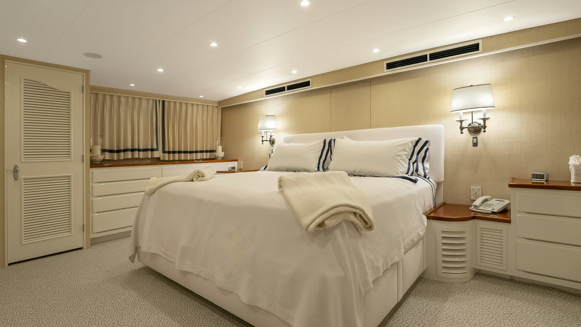 a bedroom with a bed and a desk aboard STONEFACE Yacht for Sale